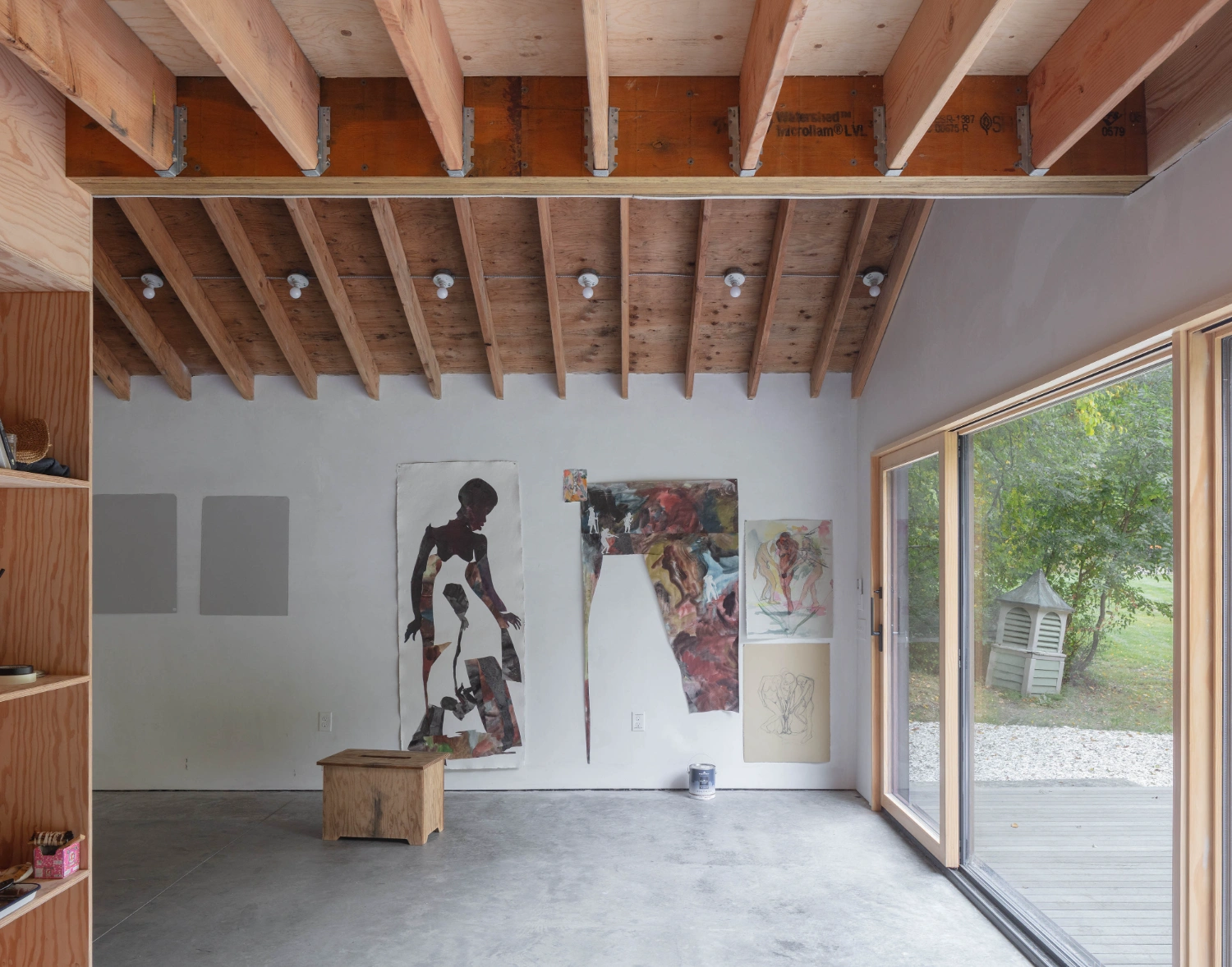 Studio Barn by Worrell Yeung — A double-height studio space with exposed timber beam ceiling and recessed lighting fixtures.
