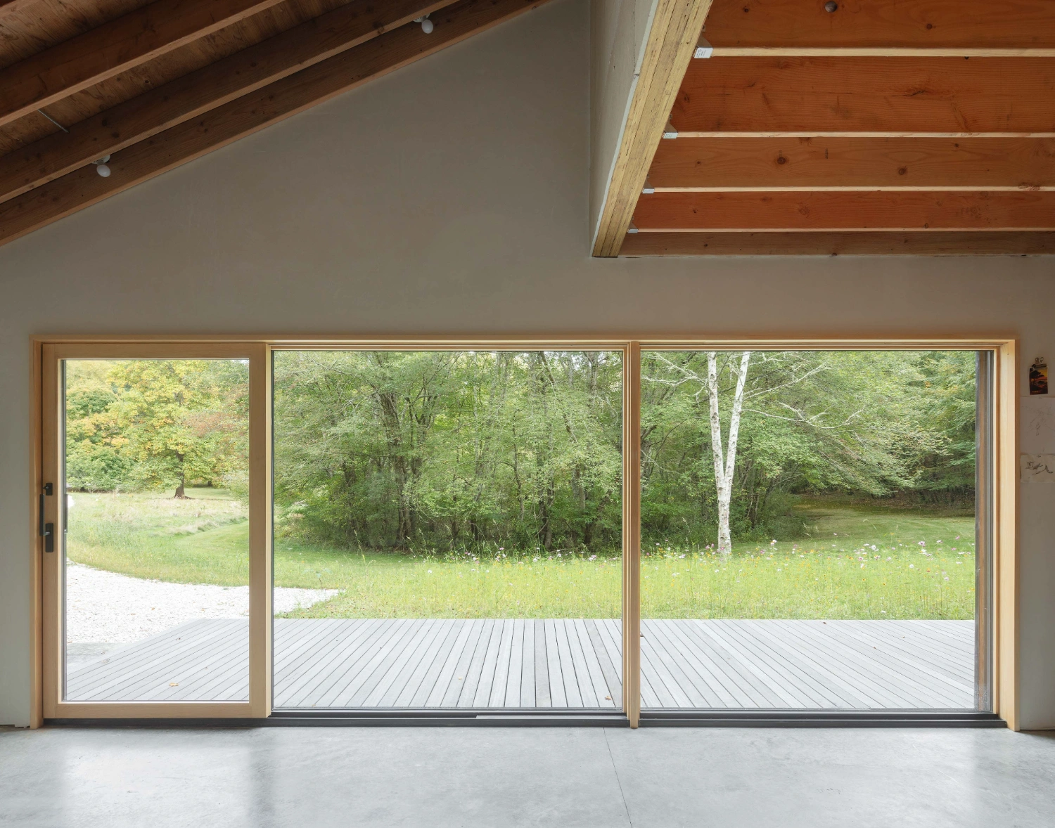 Studio Barn by Worrell Yeung — Interior view of Studio Barn looking toward the landscape through a tripartite glazed wall system.