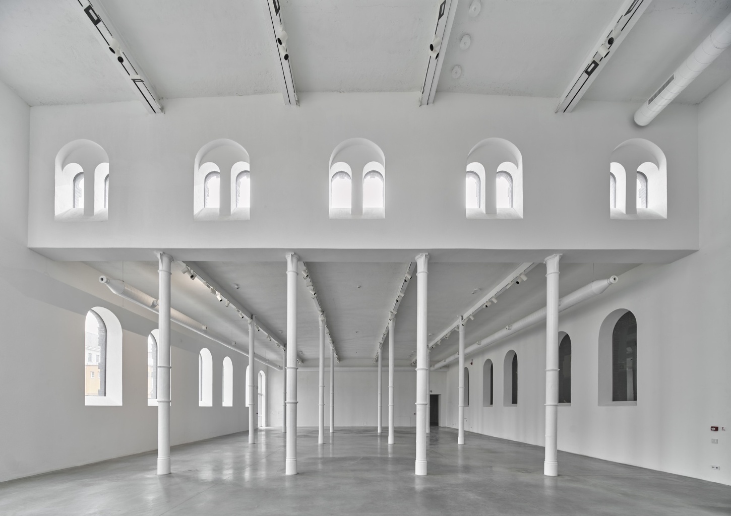 PLATO Contemporary Art Gallery by KWK PROMES — A double-height gallery interior revealing the spatial ambition of the renovated industrial structure.