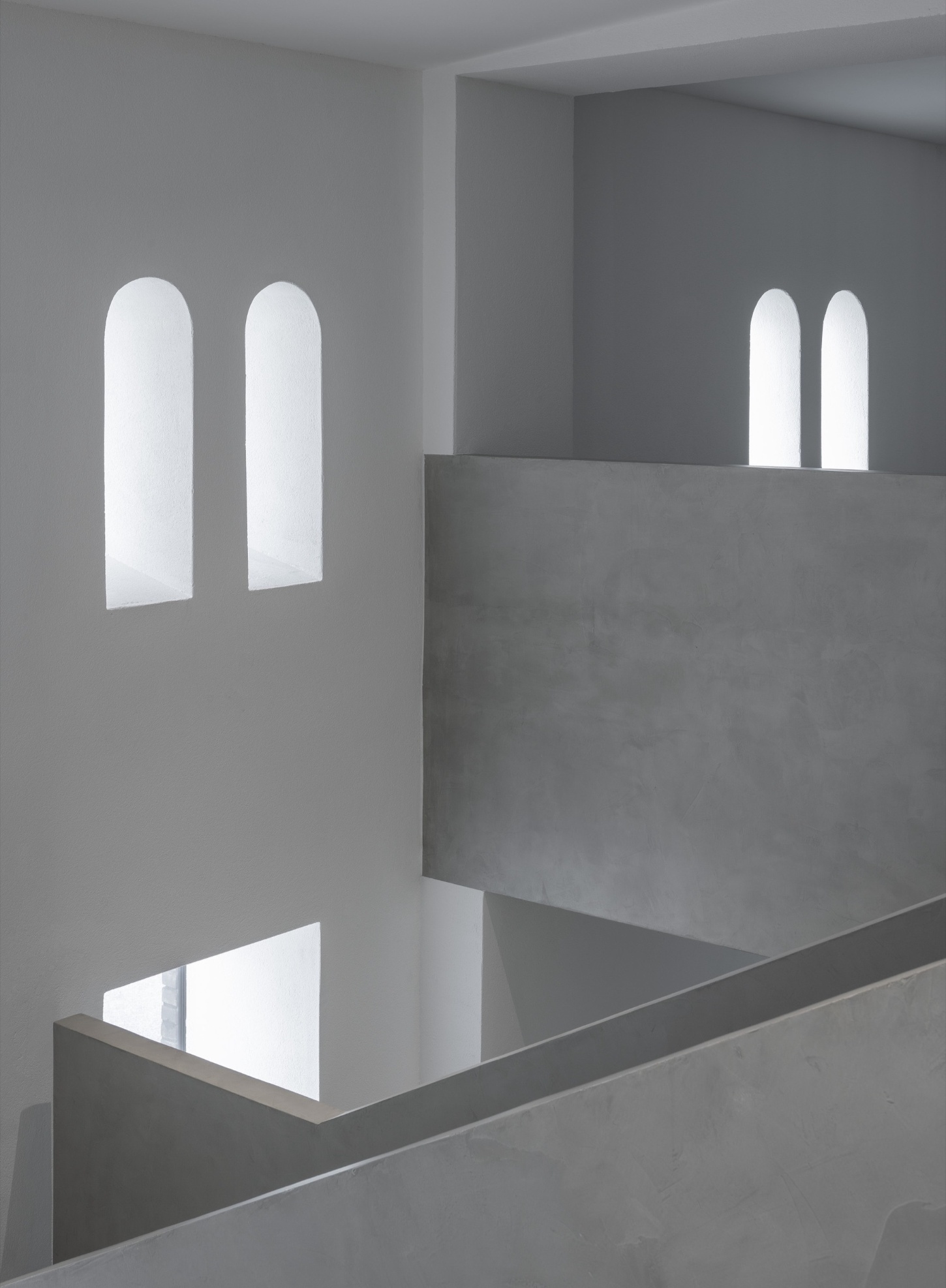 PLATO Contemporary Art Gallery by KWK PROMES — Interior view of the PLATO gallery's concrete insertion, revealing the architectural threshold between old and new.
