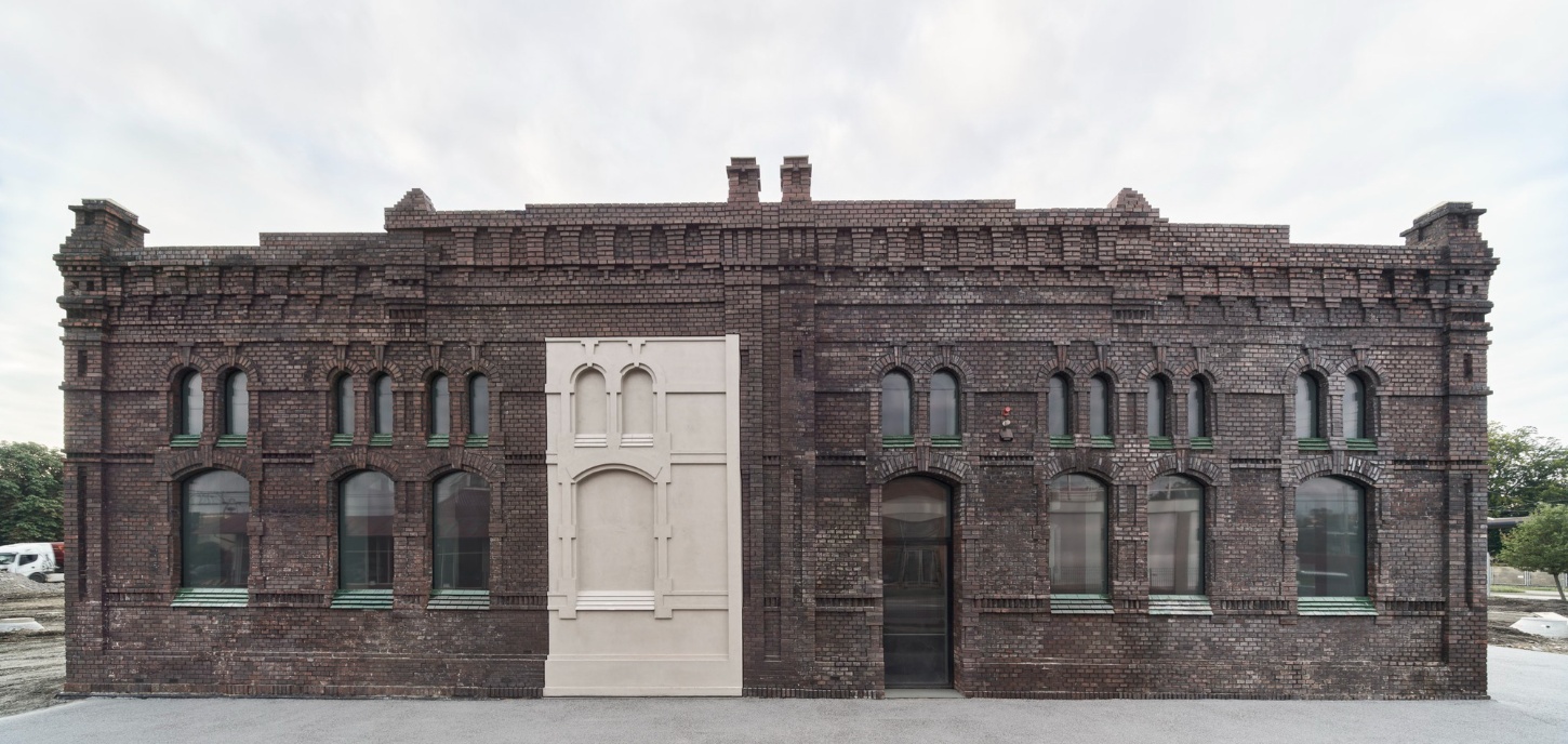 PLATO Contemporary Art Gallery by KWK PROMES — The micro-concrete pavilion inserted into the brick facade functions as a literal threshold, its geometric precision contrasting sharply against the...
