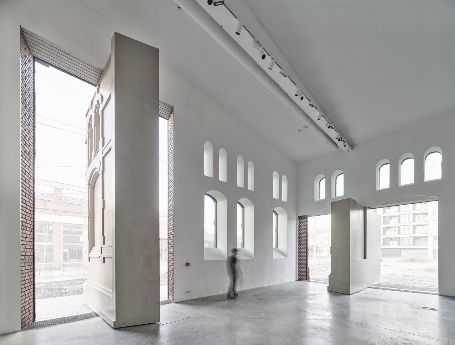 PLATO Contemporary Art Gallery by KWK PROMES — Interior view of the PLATO gallery revealing the spatial strategy of layered materials and openness.