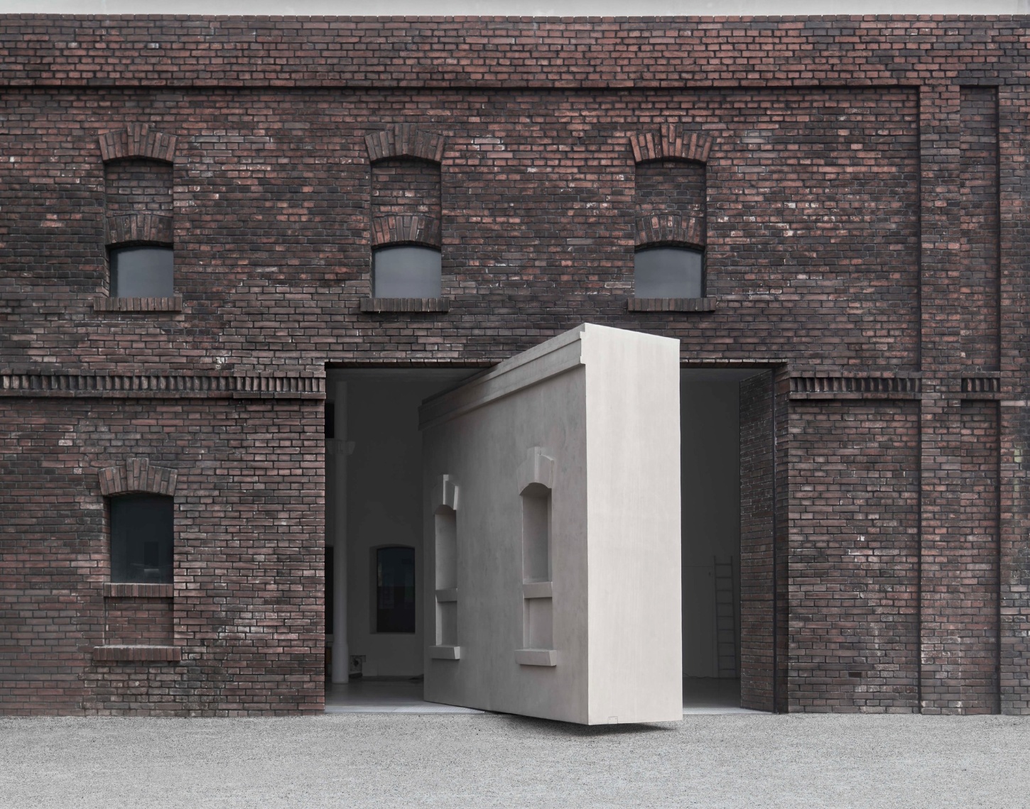 PLATO Contemporary Art Gallery by KWK PROMES — A micro-concrete pavilion with sharp rectilinear edges occupies the open threshold of a converted brick industrial building.