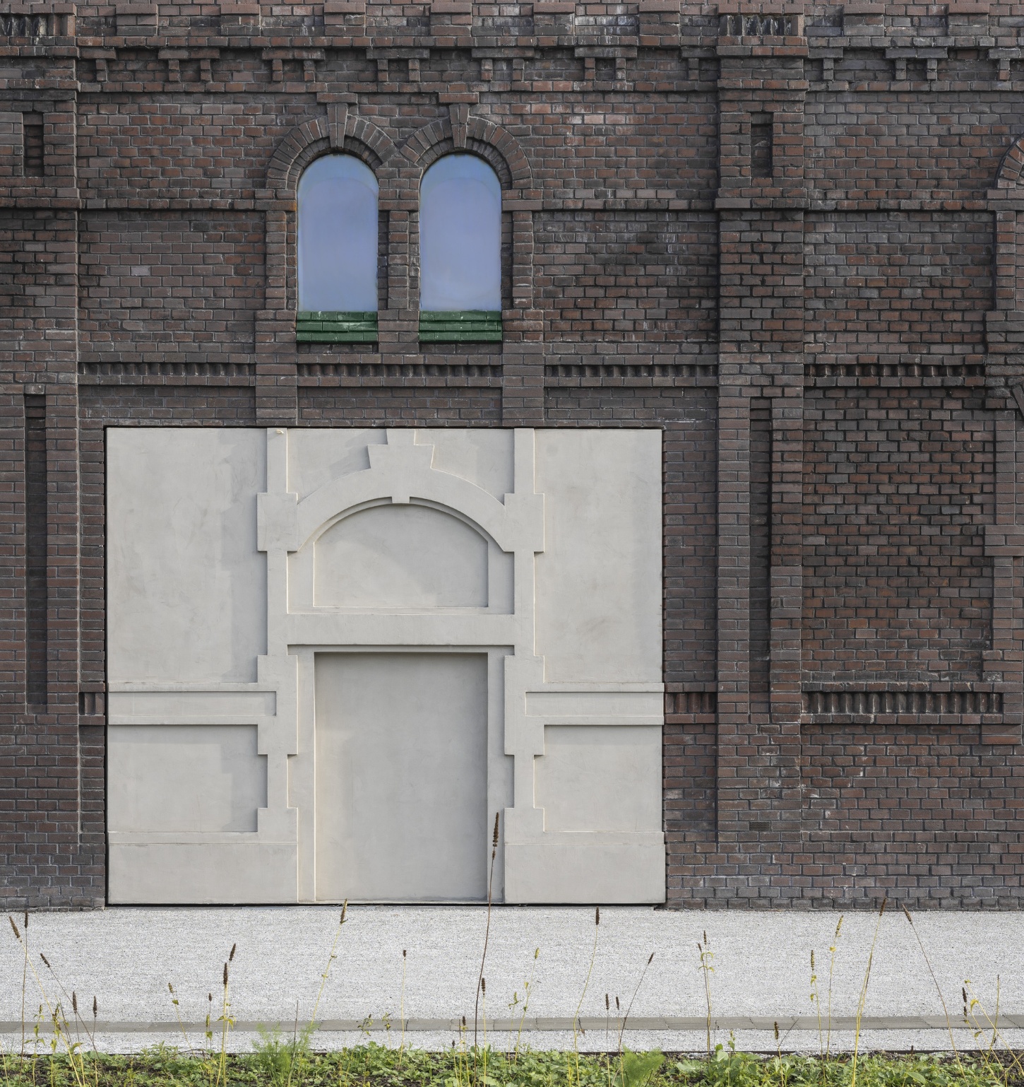 PLATO Contemporary Art Gallery by KWK PROMES — A micro-concrete pavilion with sharp rectilinear geometry fills the brick opening of the gallery facade.