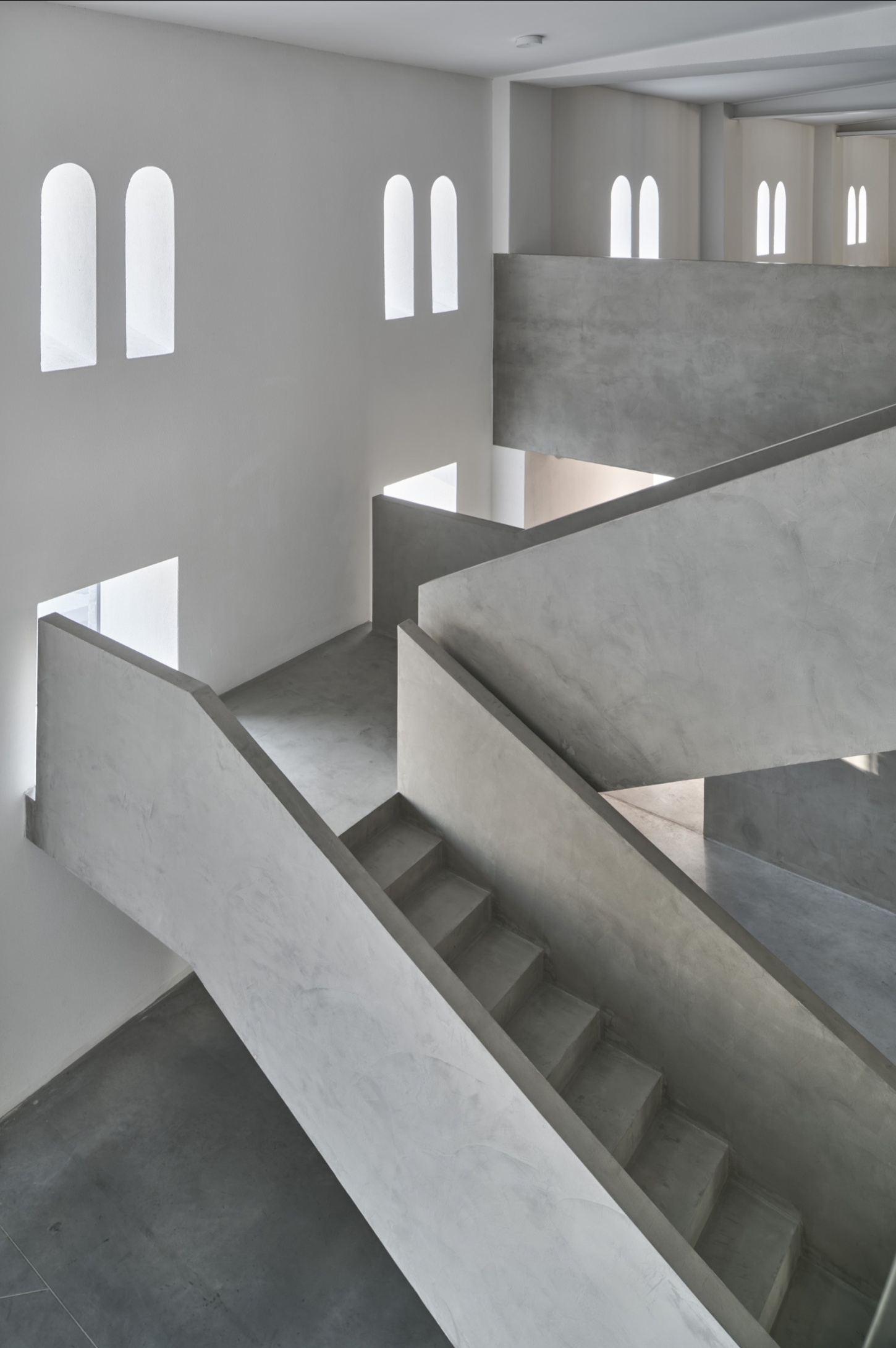 PLATO Contemporary Art Gallery by KWK PROMES — A multi-level concrete interior reveals the gallery's spatial complexity through a sectional view.