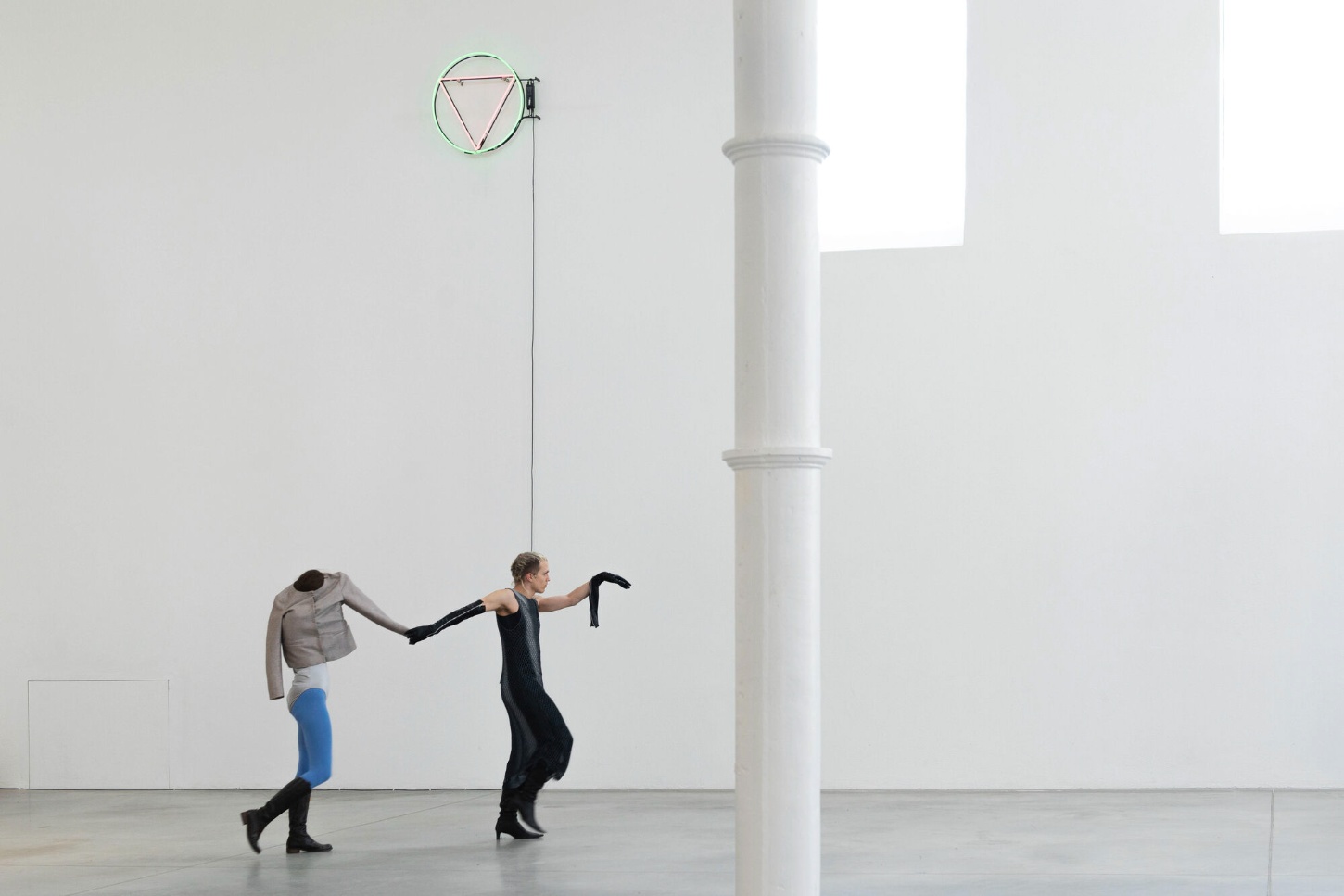 PLATO Contemporary Art Gallery by KWK PROMES — Two figures interact within the gallery's monumental interior, their bodies framing the architectural intervention.