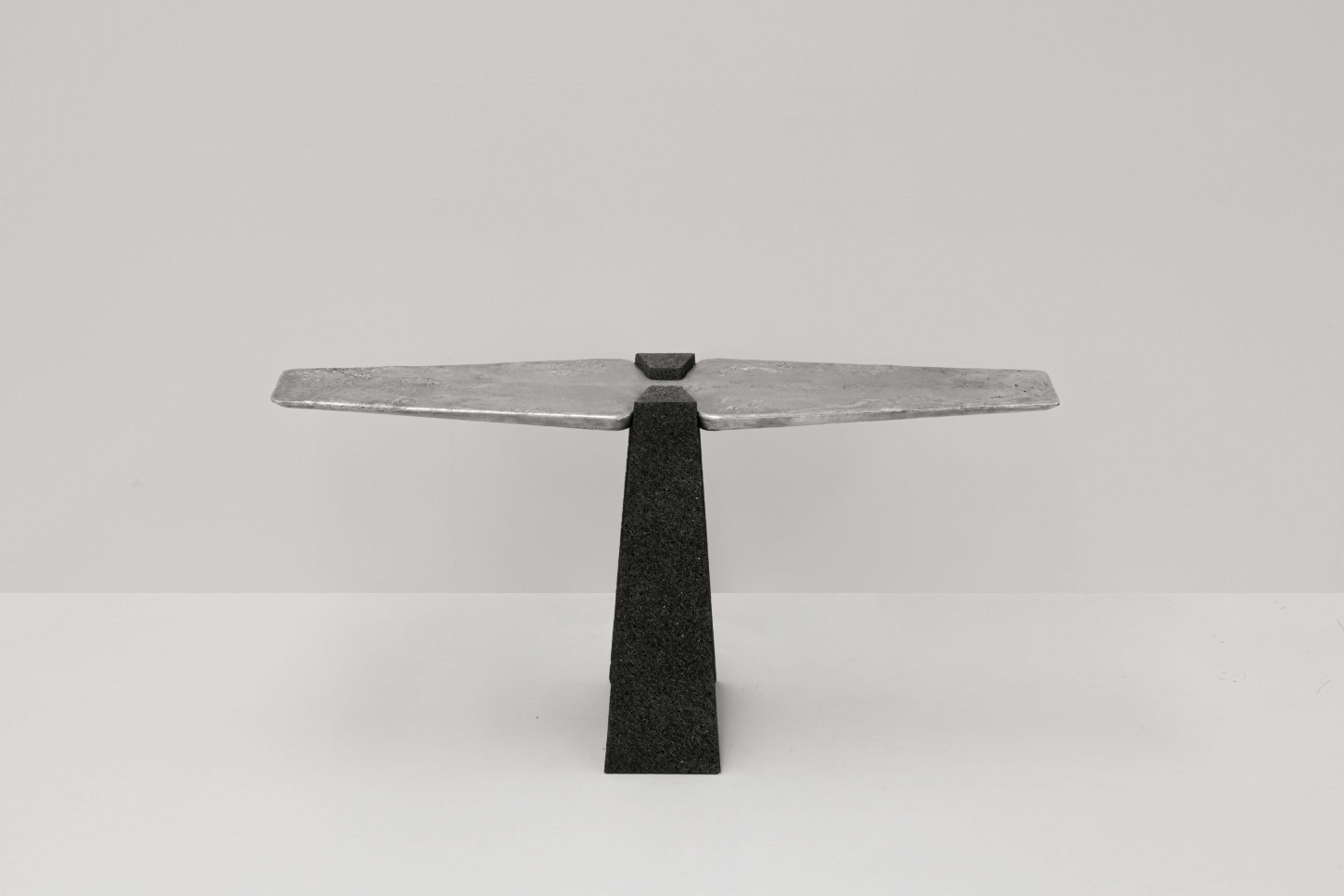 EXHUMA by EWE Studio merges volcanic stone with sand-cast aluminum, echoing Purépecha metalwork