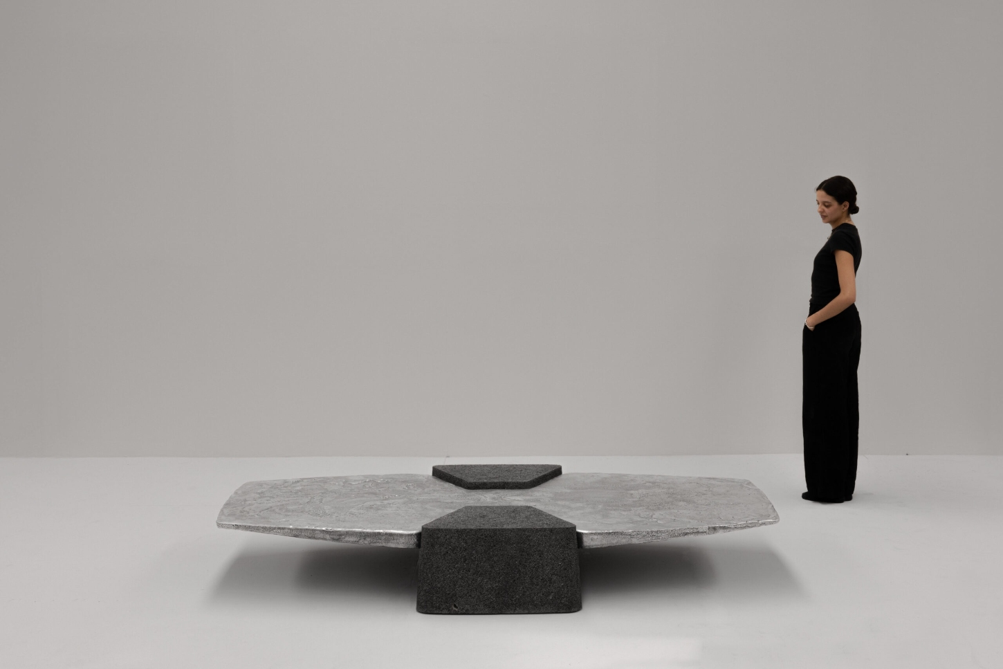 EXHUMA by EWE Studio merges volcanic stone with sand-cast aluminum, echoing Purépecha metalwork