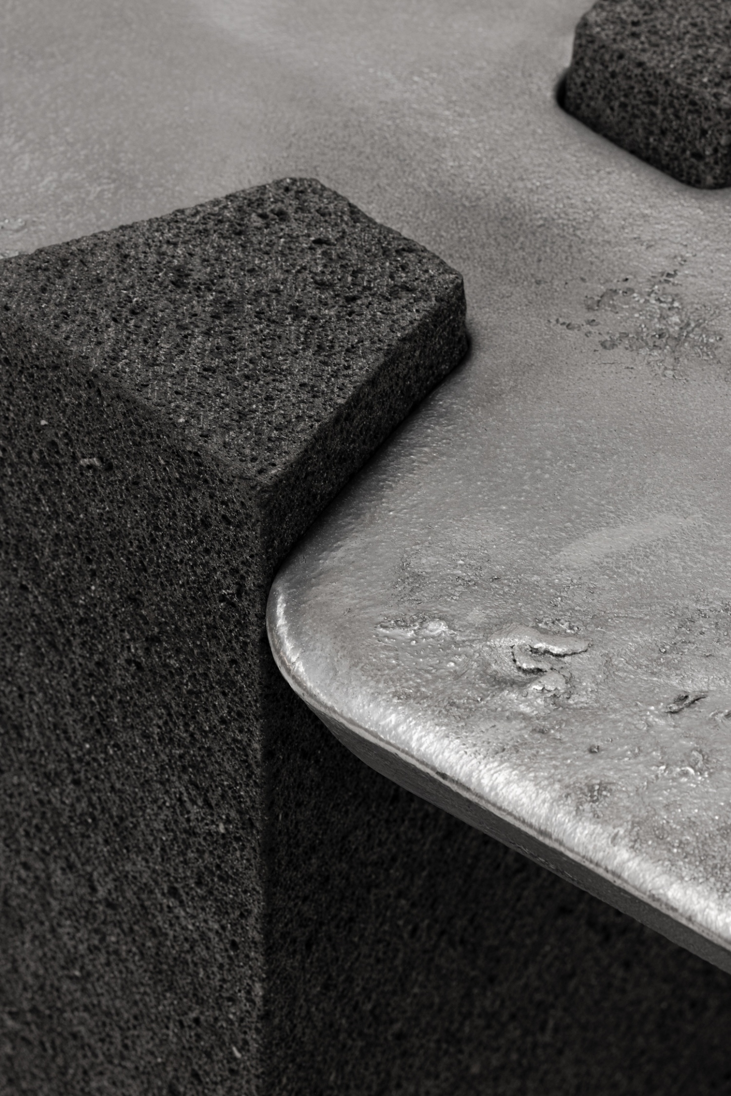 EXHUMA by EWE Studio merges volcanic stone with sand-cast aluminum, echoing Purépecha metalwork