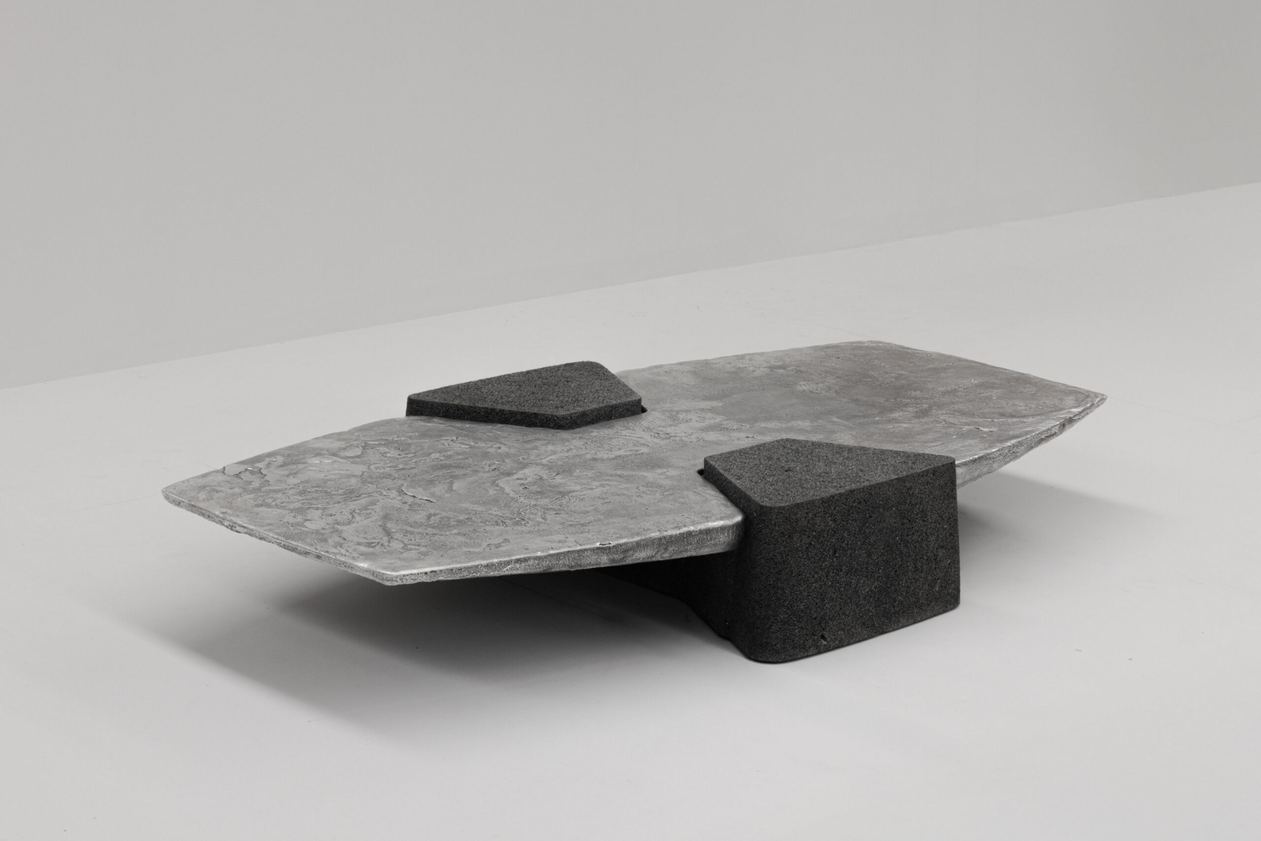 EXHUMA by EWE Studio merges volcanic stone with sand-cast aluminum, echoing Purépecha metalwork