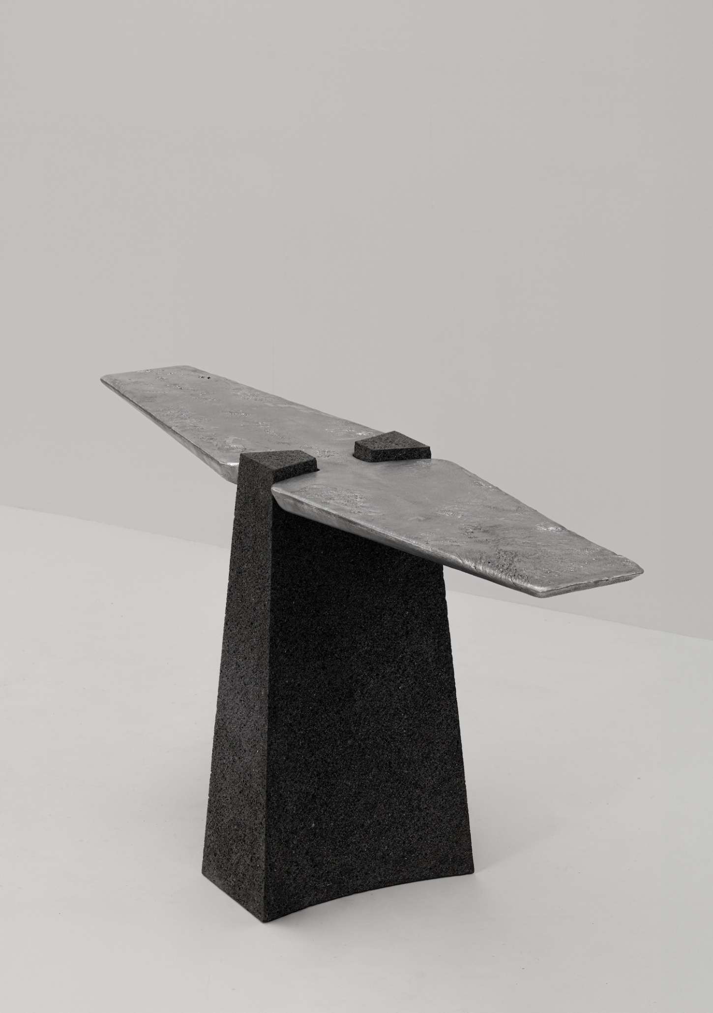 EXHUMA by EWE Studio merges volcanic stone with sand-cast aluminum, echoing Purépecha metalwork