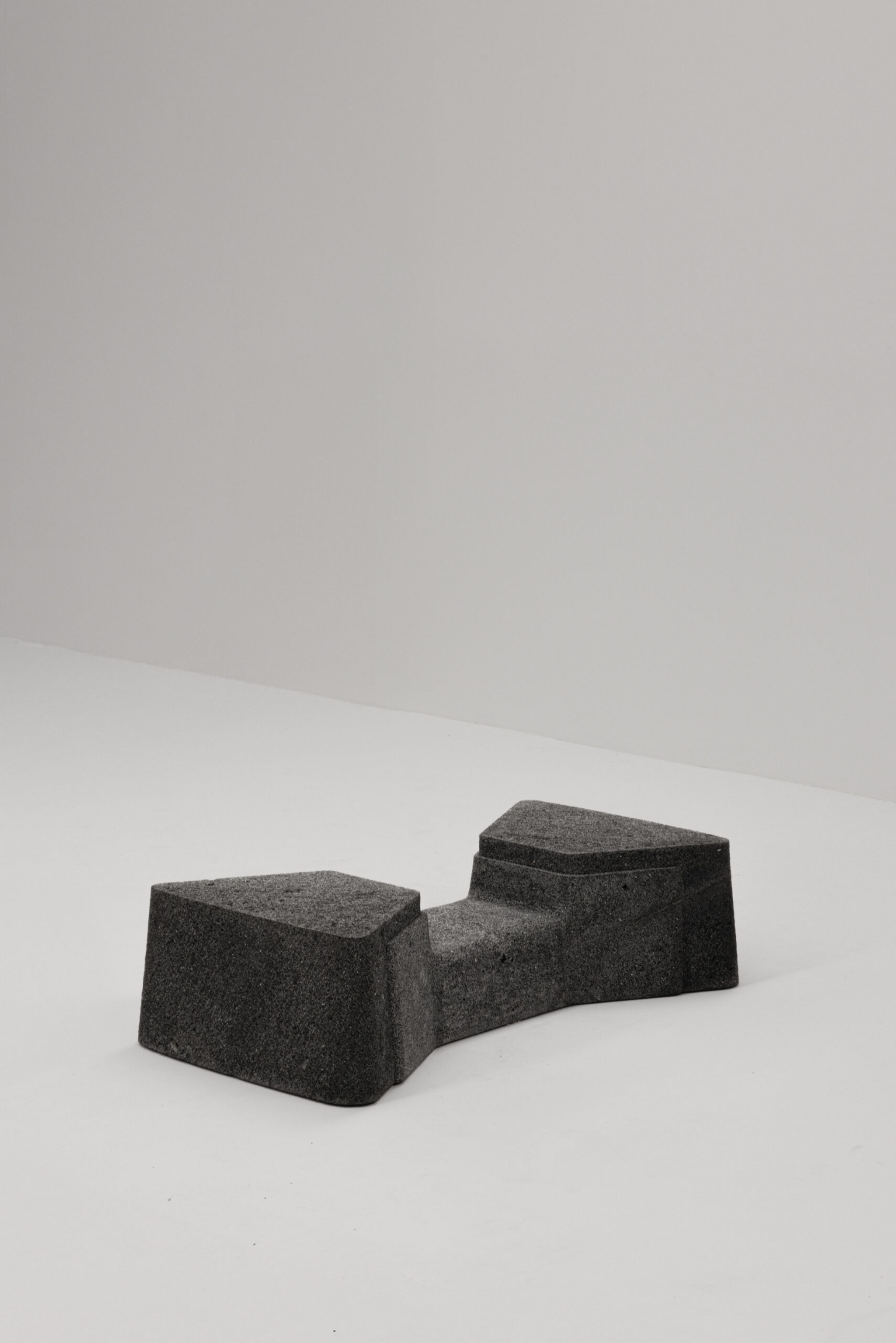 EXHUMA by EWE Studio merges volcanic stone with sand-cast aluminum, echoing Purépecha metalwork