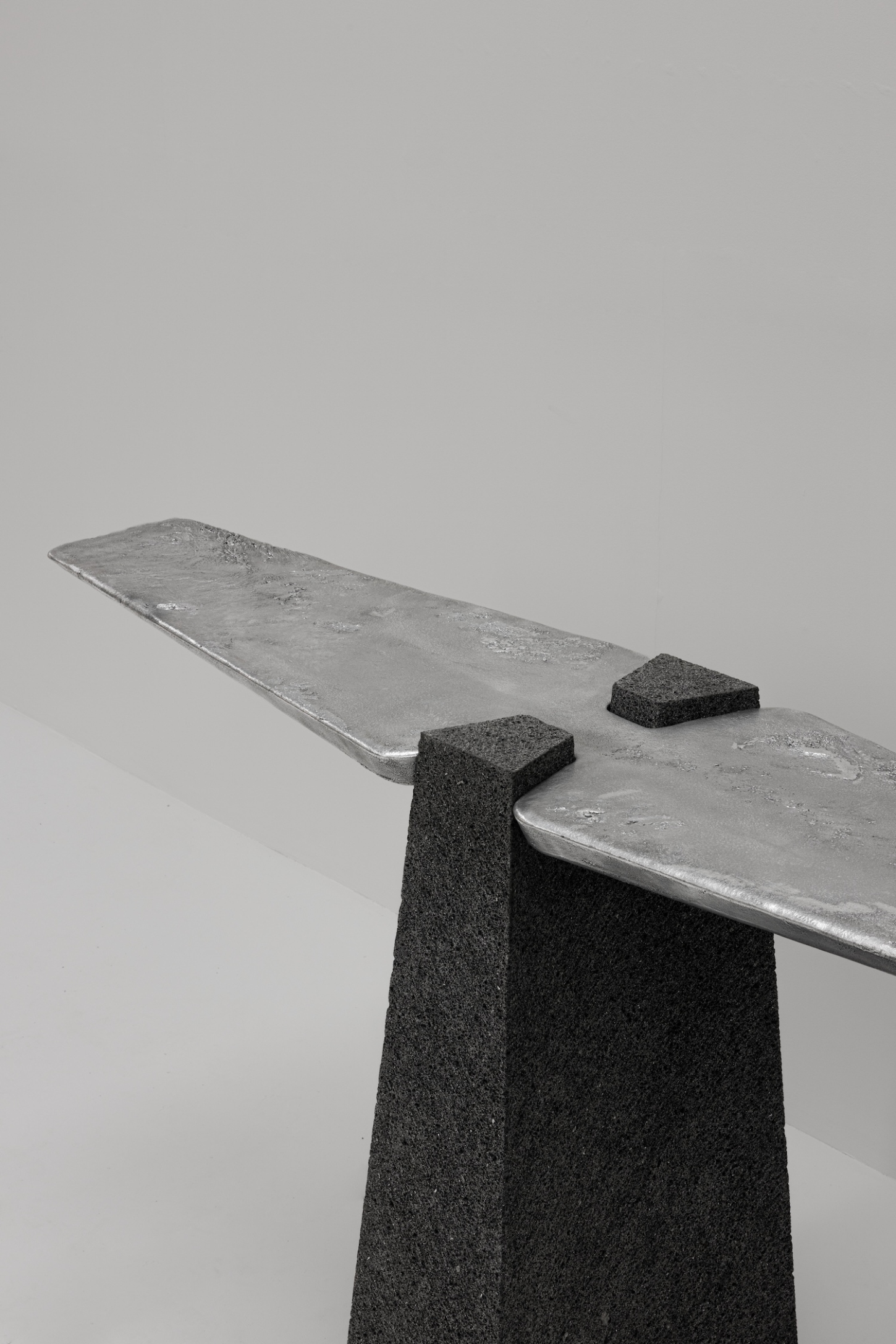EXHUMA by EWE Studio merges volcanic stone with sand-cast aluminum, echoing Purépecha metalwork