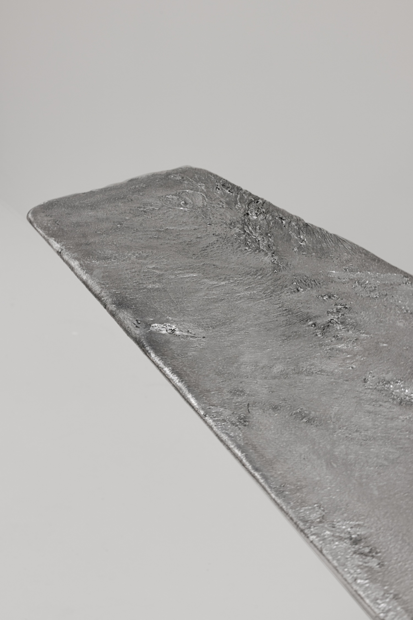 EXHUMA by EWE Studio merges volcanic stone with sand-cast aluminum, echoing Purépecha metalwork