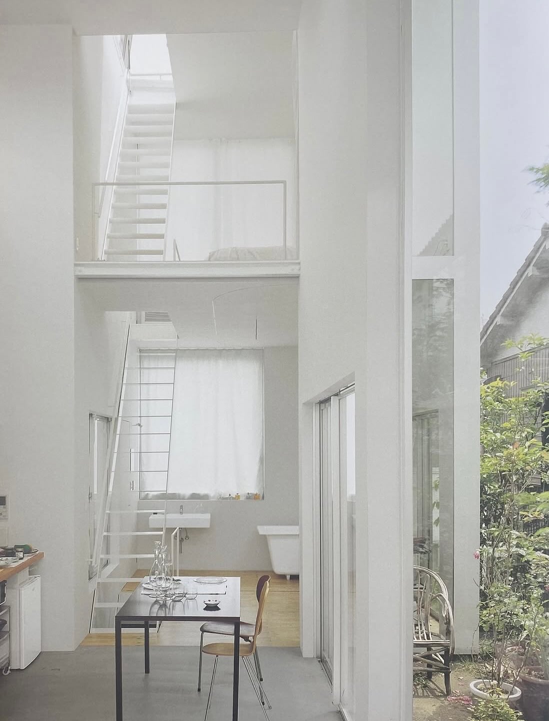 House A by Ryue Nishizawa — A compressed domestic interior demonstrates spatial layering through transparent glass partitions.