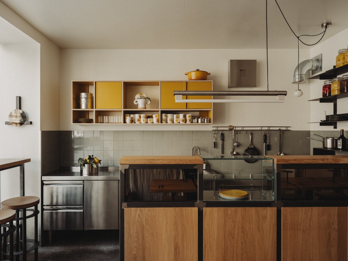 Amator Restaurant by wiercinski-studio — The kitchen workspace of Amator reveals a methodical approach to compact commercial cooking.