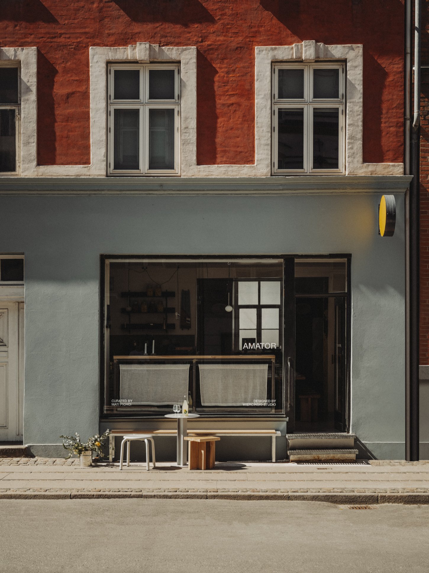 Amator Restaurant by wiercinski-studio — The storefront of Amator presents a studied restraint typical of contemporary Copenhagen design.