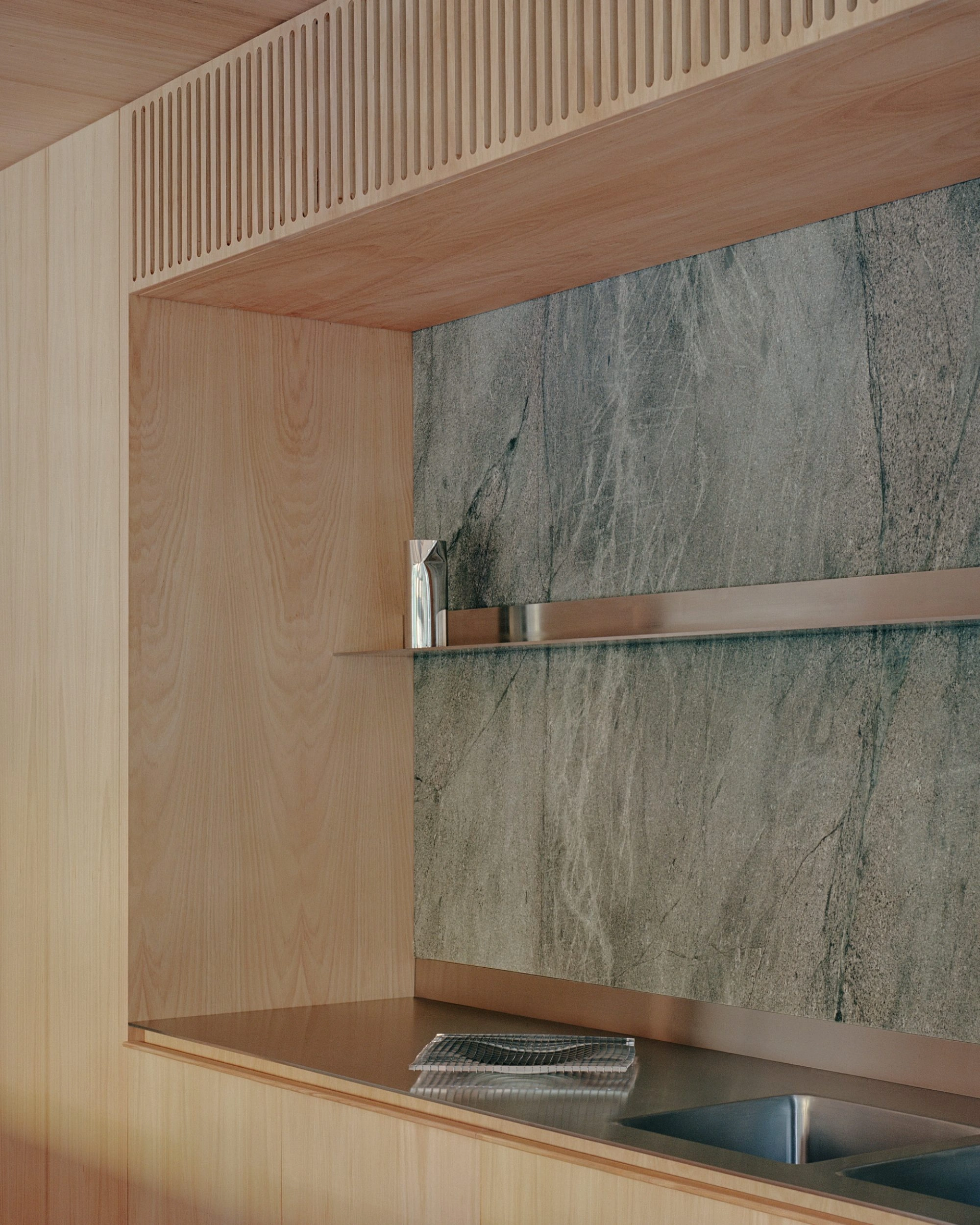 Echo House by Parabolica — A kitchen alcove detailed with material contrasts and functional minimalism.