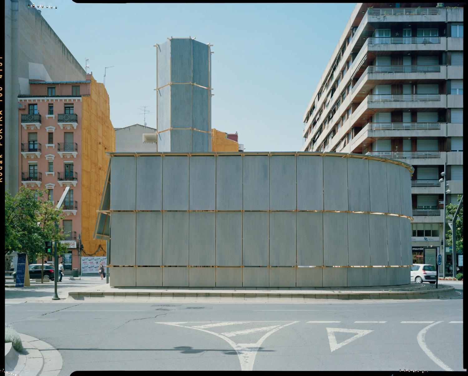 Round About Baths by Leopold Banchini — Leopold Banchini's Round About Baths occupies a traffic roundabout in Logroño with a utilitarian structure of translucent polycarbonate upper panels...