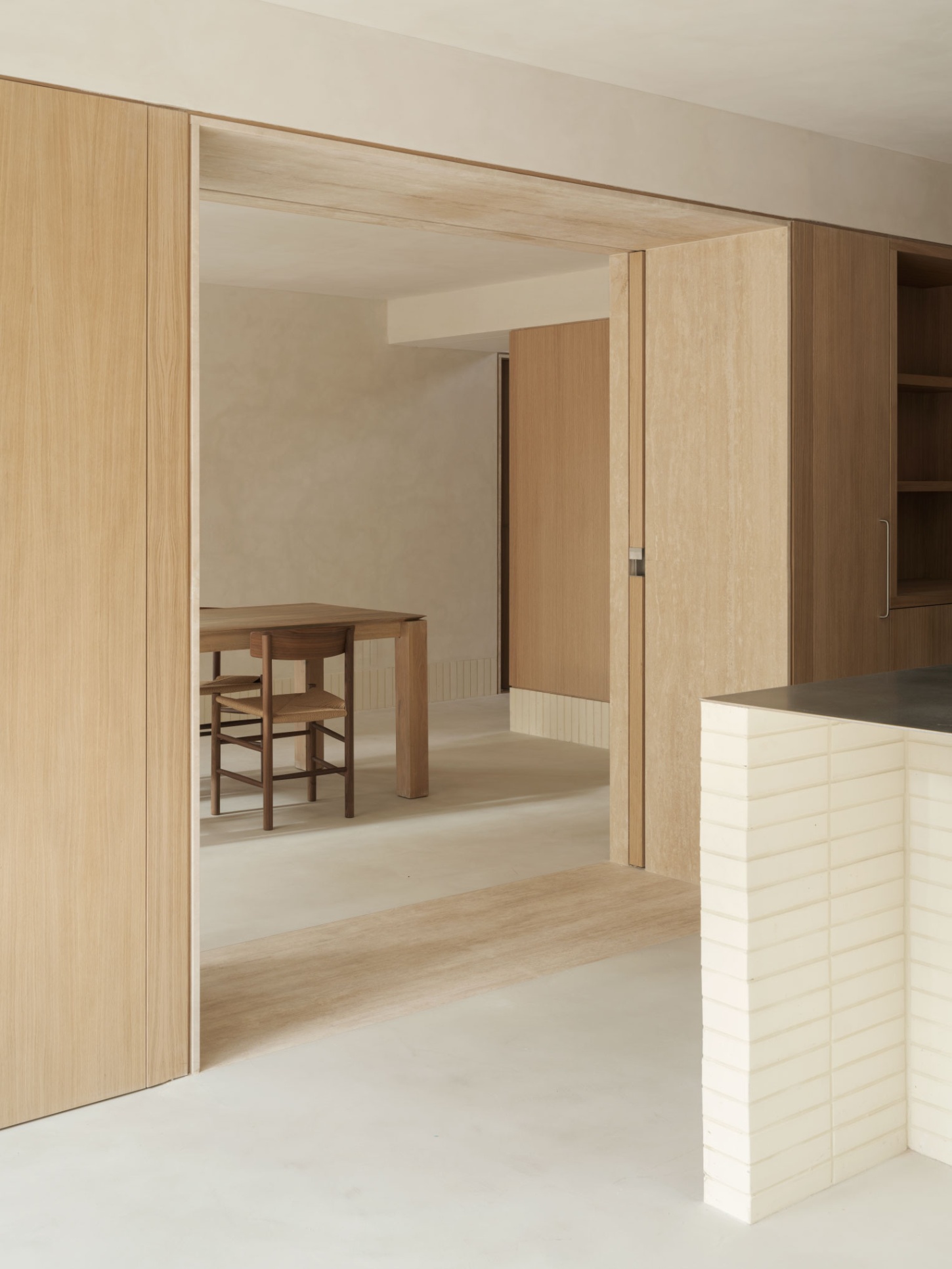 Casa SO by Studio DIIR — A timber-framed threshold punctuates the domestic sequence, its recessed depth establishing a layered passage that compresses before releasing into a...