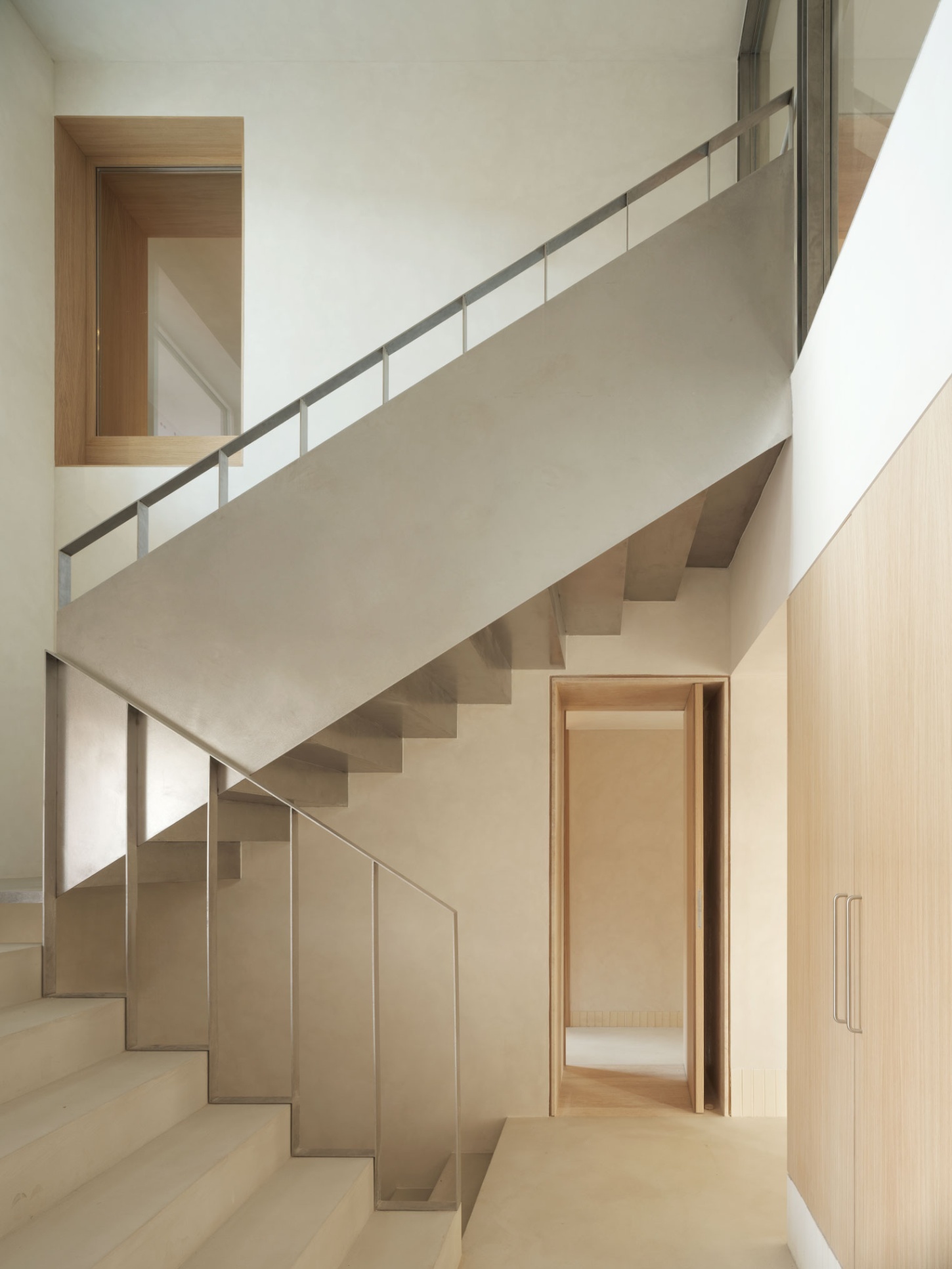 Casa SO by Studio DIIR — A double-height stairwell articulated through timber and steel materiality.