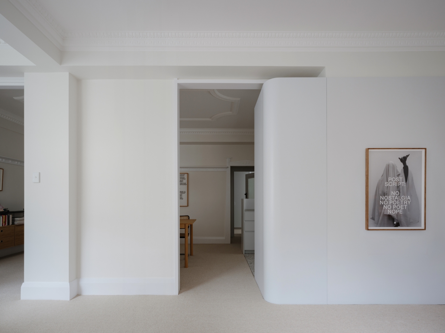 Onslow Gardens Apartment by Youssofzay Hart — A white-walled interior threshold frames the transition between living and dining spaces.
