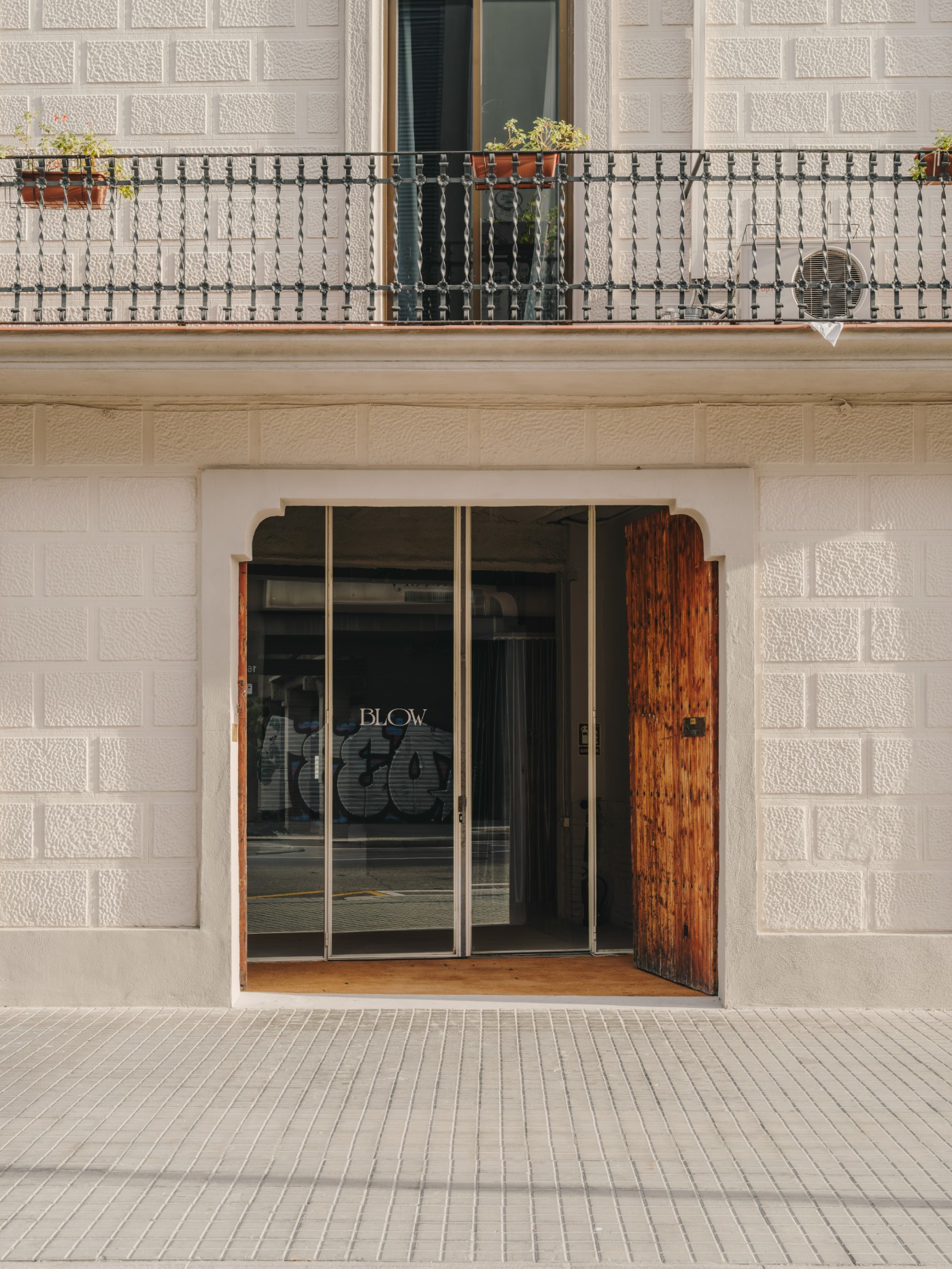Blow Studio by Isern Serra — The street-facing facade of Blow Studio presents a restrained commercial threshold.