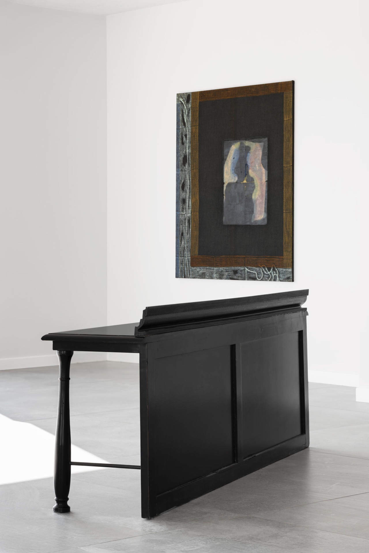 What You See is Not Here Tomorrow by Radek Brousil at Krupa Gallery — A black-painted wooden desk with angled leg and recessed storage compartment occupies the gallery floor, its volumetric form anchoring the lower register of...