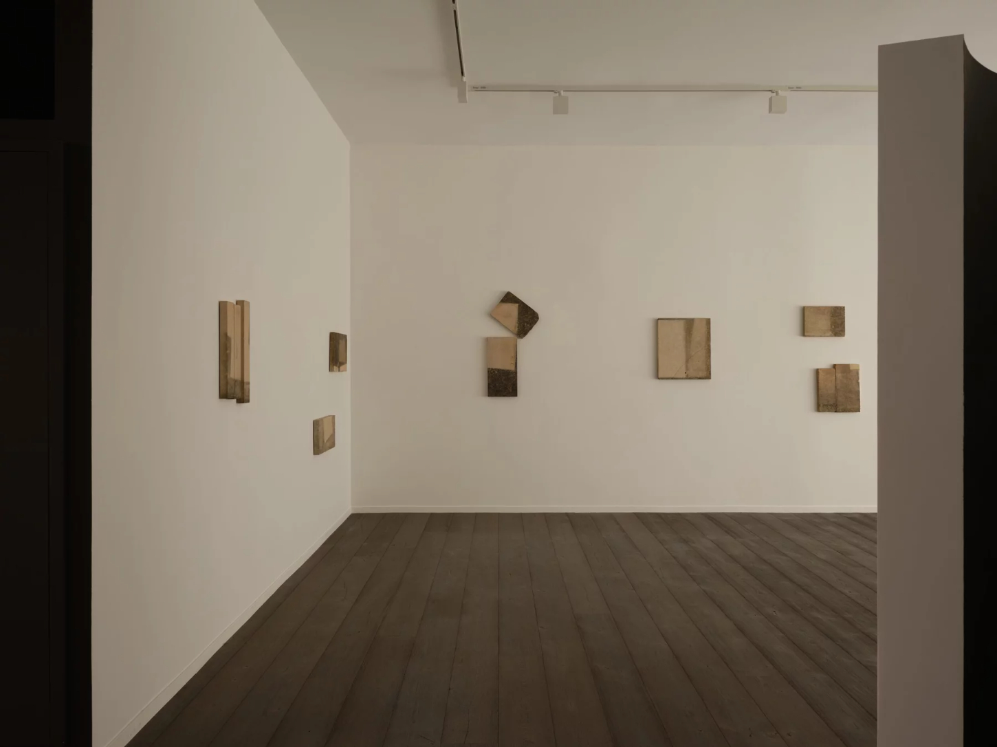 ‘Untitled’ by JAMESPLUMB & Garcé Dimofski at Francis Gallery — A gallery interior displaying wall-mounted stone fragments in varying states of weathering.