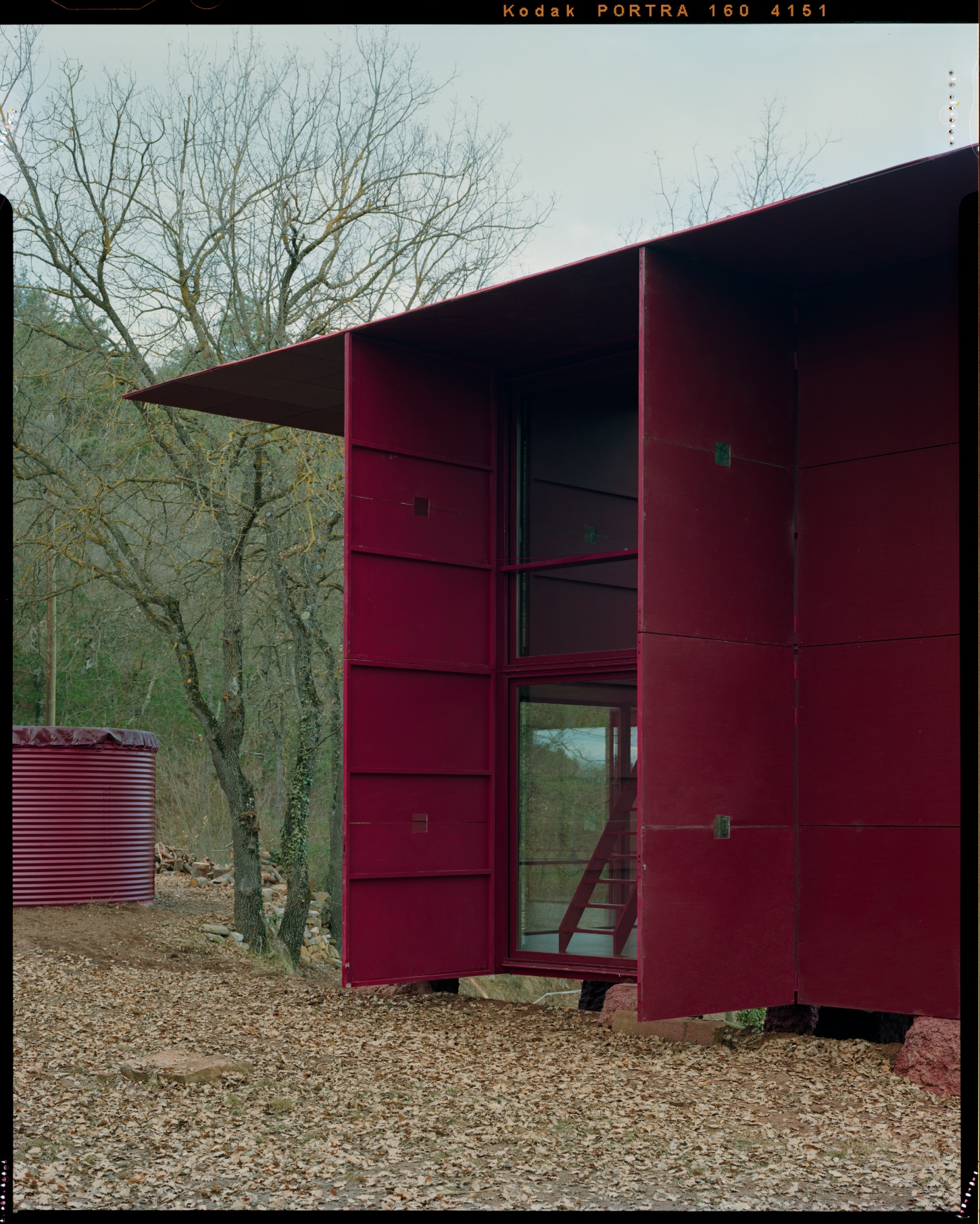 TEST perches prefab wooden house atop shotcrete pillars in barcelona woodlands spain