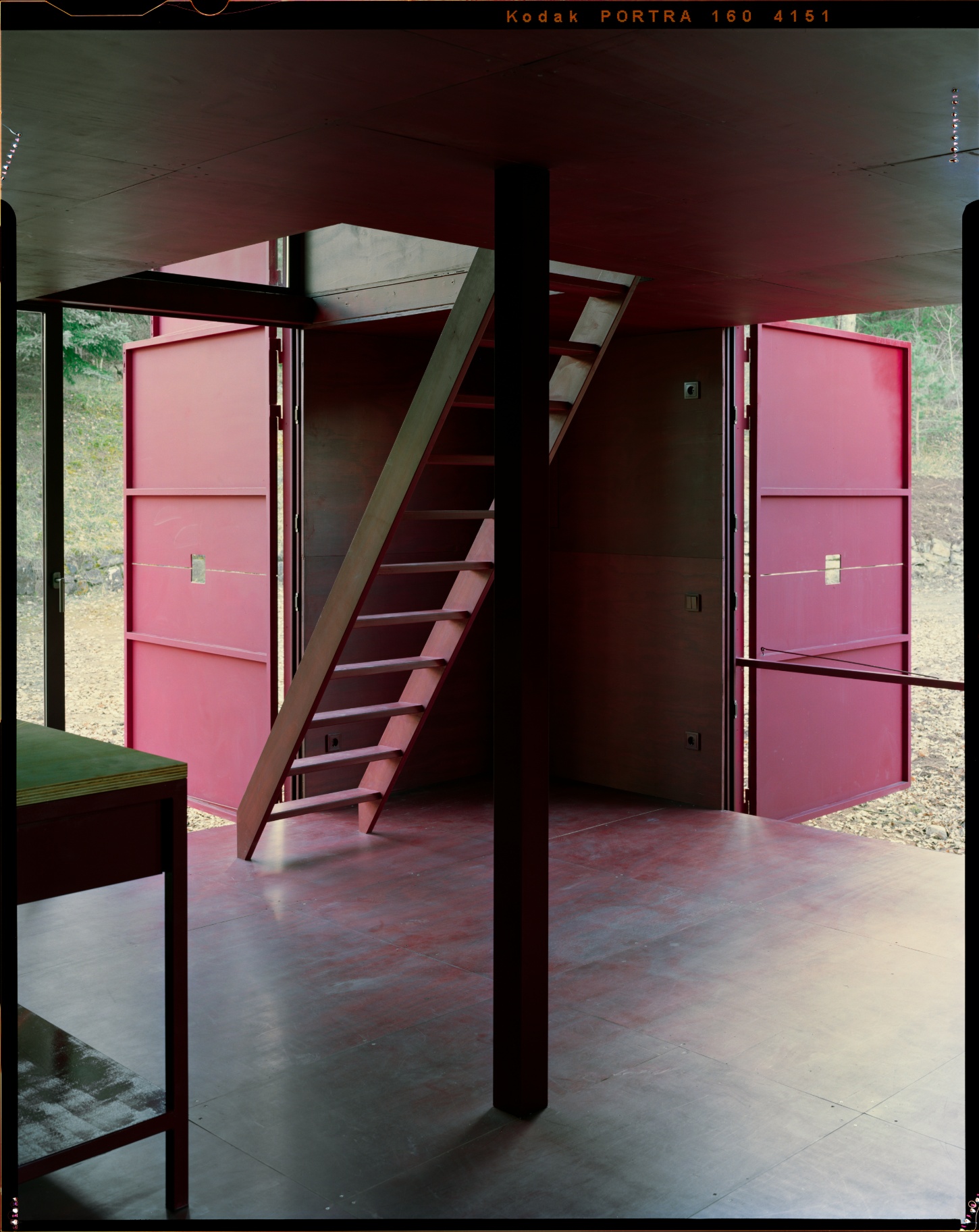 TEST perches prefab wooden house atop shotcrete pillars in barcelona woodlands spain