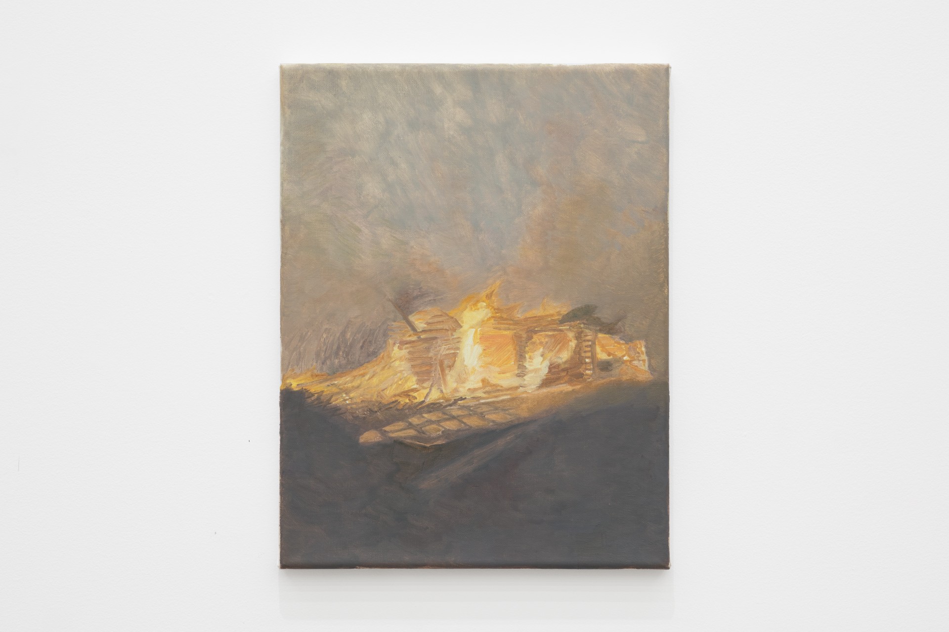 Mouthful of Dirty Copper by Rexy Tseng at Magenta Plains — A single canvas dominates the frame, depicting a burning wooden structure rendered in golden yellows and oranges against a murky grey-brown ground.