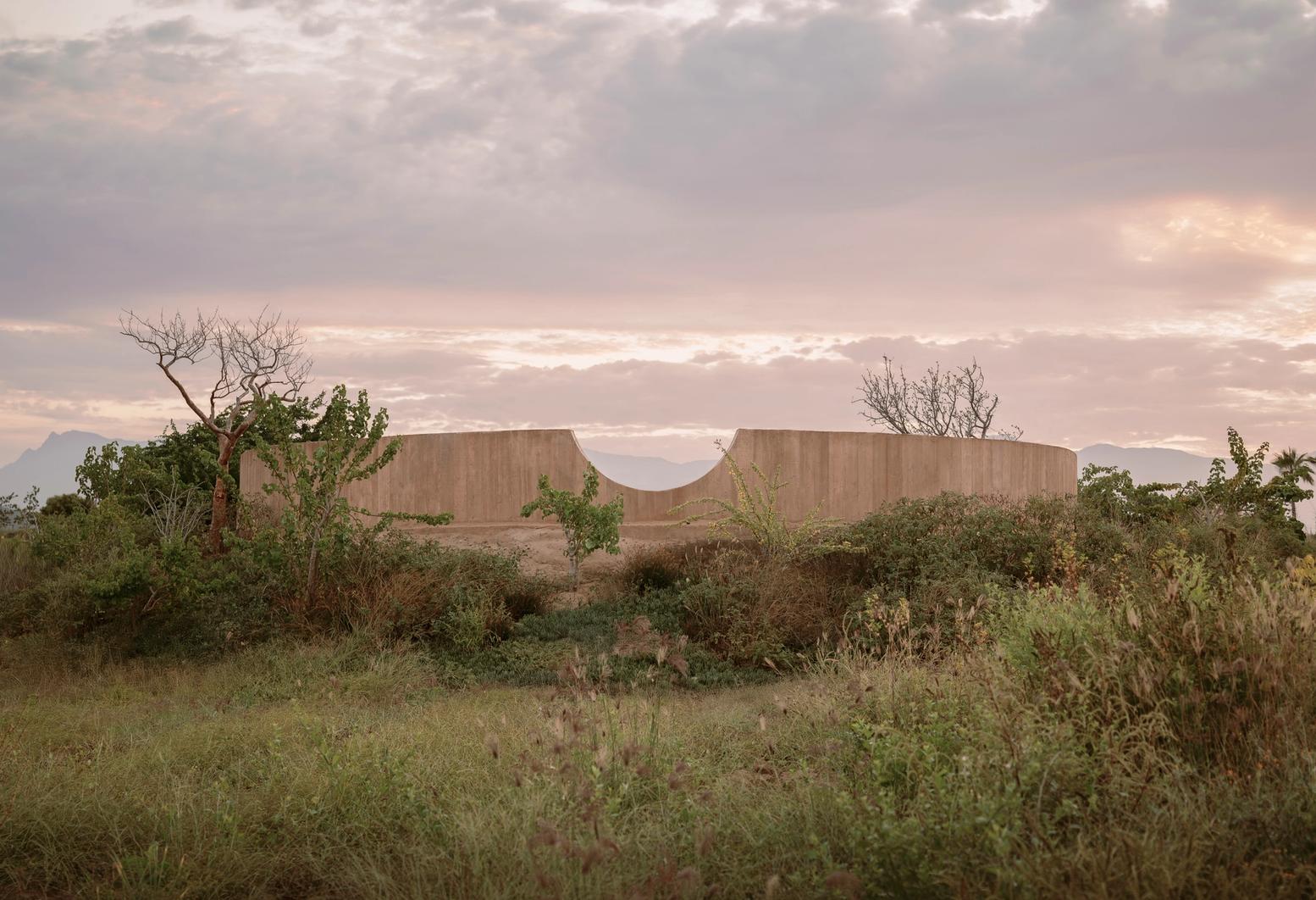 Spiritual Enclosure by Ruben Valdez — Two symmetrical curved concrete walls define a monumental enclosure within the Baja California Desert scrubland.