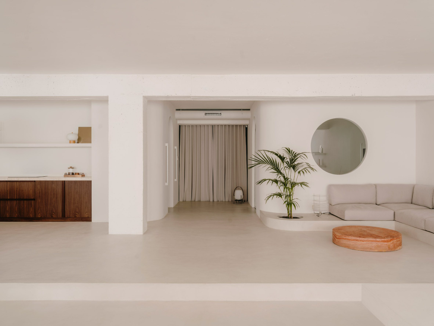 Isern Serra Studio — A 200-square-meter open-plan studio in Barcelona's Poblenou district, characterized by whitewashed plaster walls and exposed concrete ceiling with visible...