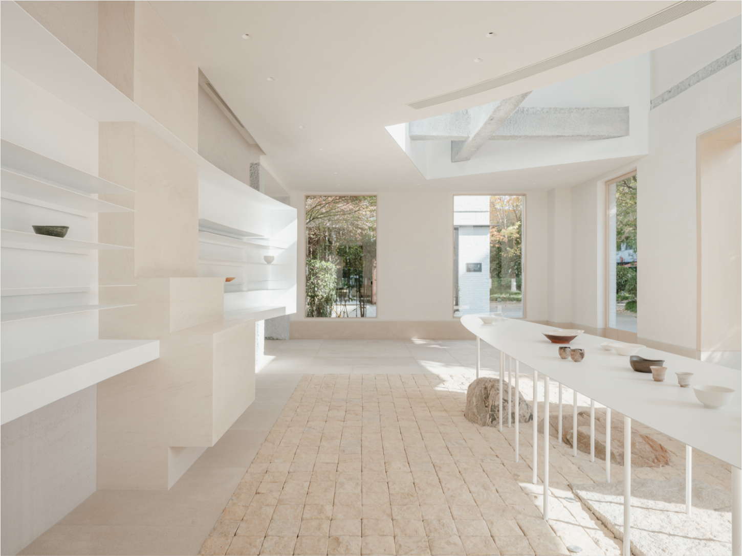 JIA Garden by Mountain Soil — A longitudinal interior view of the JIA Garden showroom showcasing a minimalist retail display.