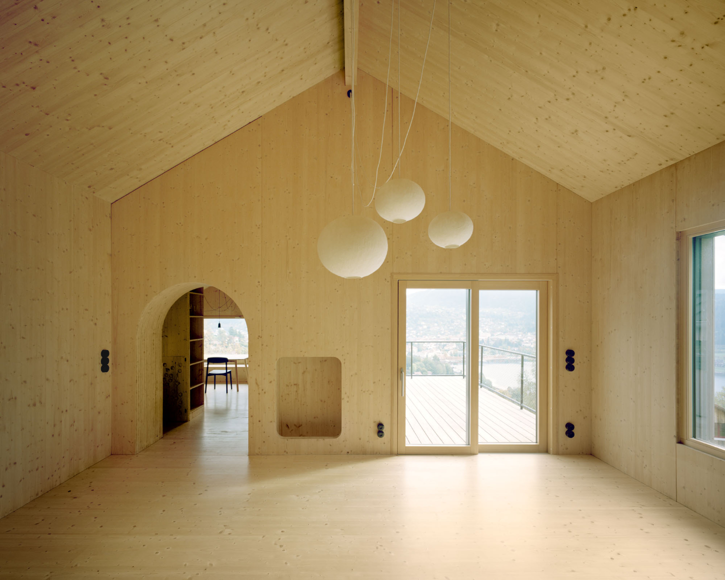 Maison Hiltiti captured by Rasmus Norlander by Atelier Ordinaire — A timber-lined interior chamber with cross-laminated construction visible across walls and pitched ceiling.