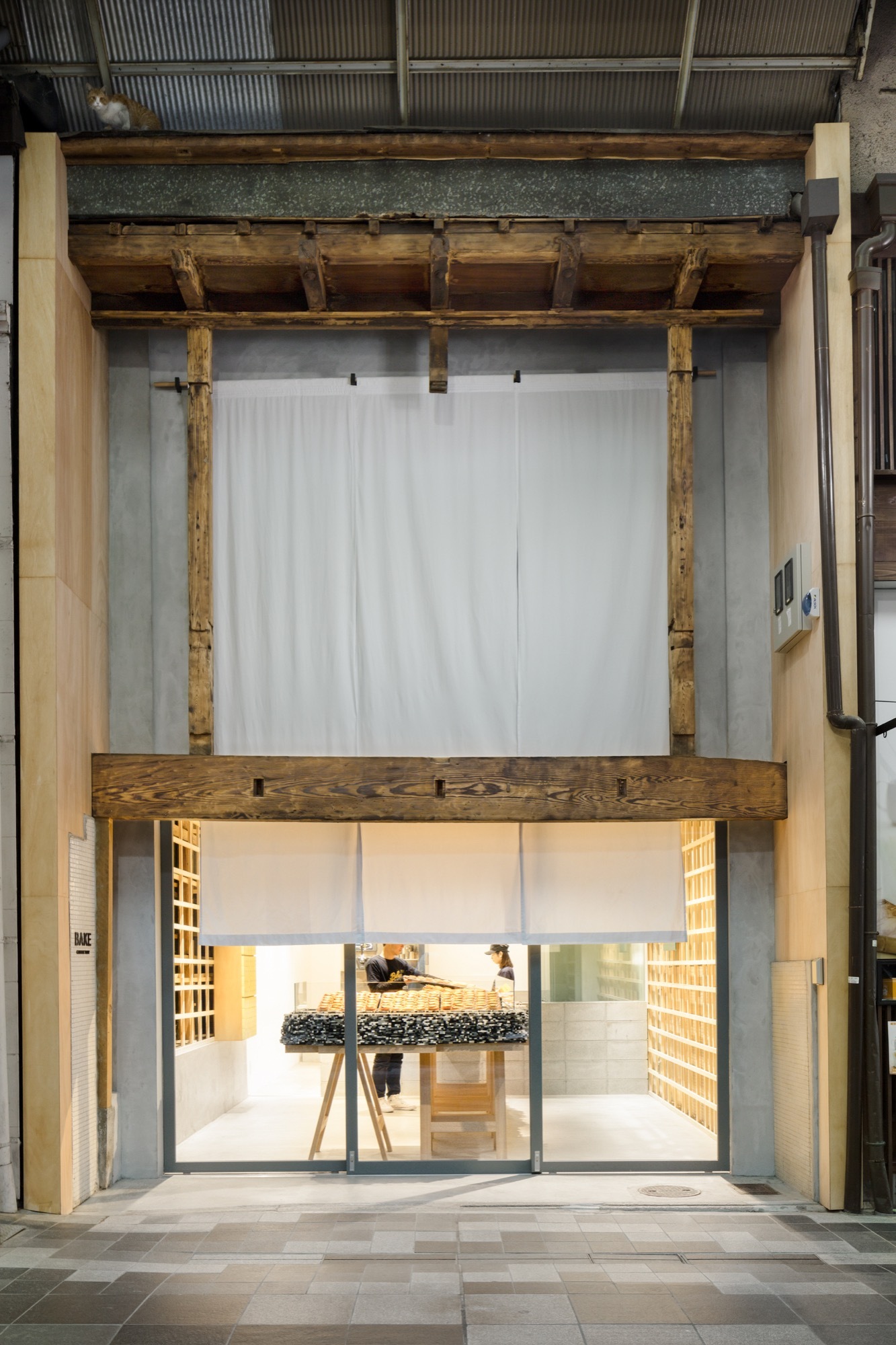 Bake Cheese Tart Store Kyoto by Yusuke Seki — The storefront elevation reveals a deliberate layering of materiality and transparency.