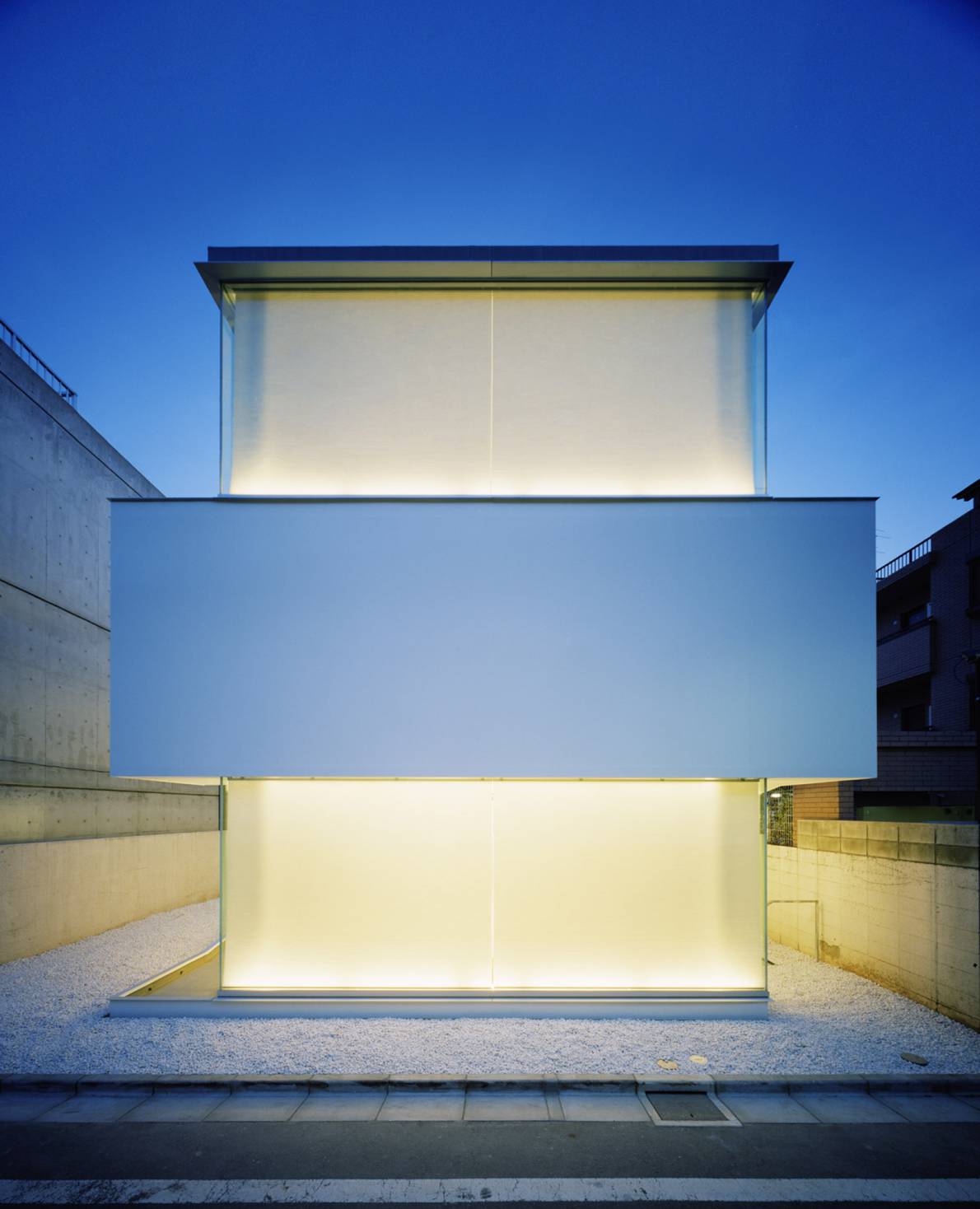 C1 House by Curiosity + Milligram Studio — The C1 House presents a rigorously geometric facade divided into three stacked volumes.
