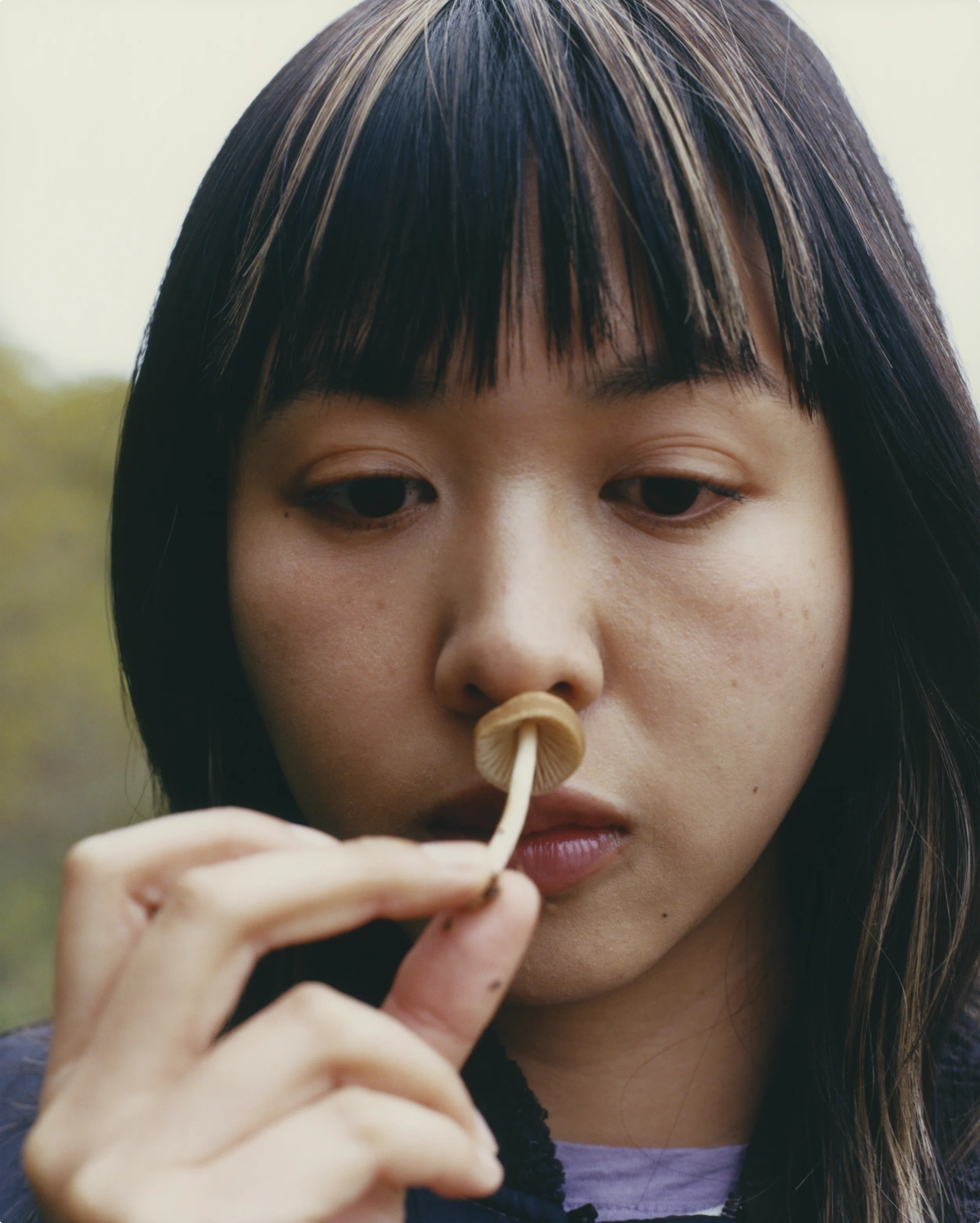 Little Things Mean a Lot by Sirui Ma — A close-up portrait of a young woman with black hair and blunt bangs, eyes downcast in gentle repose.