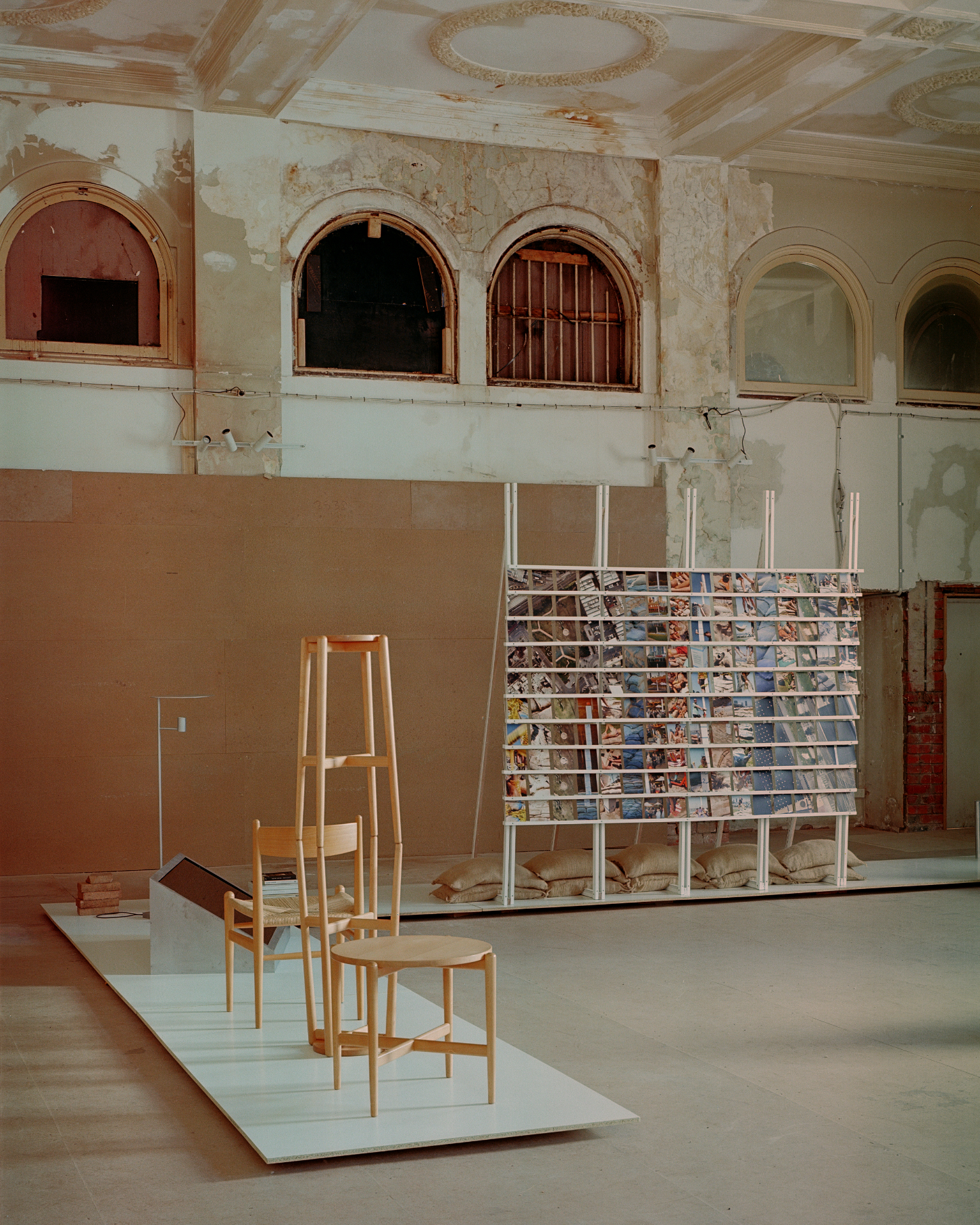 'Call Out' by DO WORKS — DO WORKS' 'Call Out' installation presents a timber lamp constructed from stacked pine blocks supporting a thin steel pole with asymmetrical cylindrical...