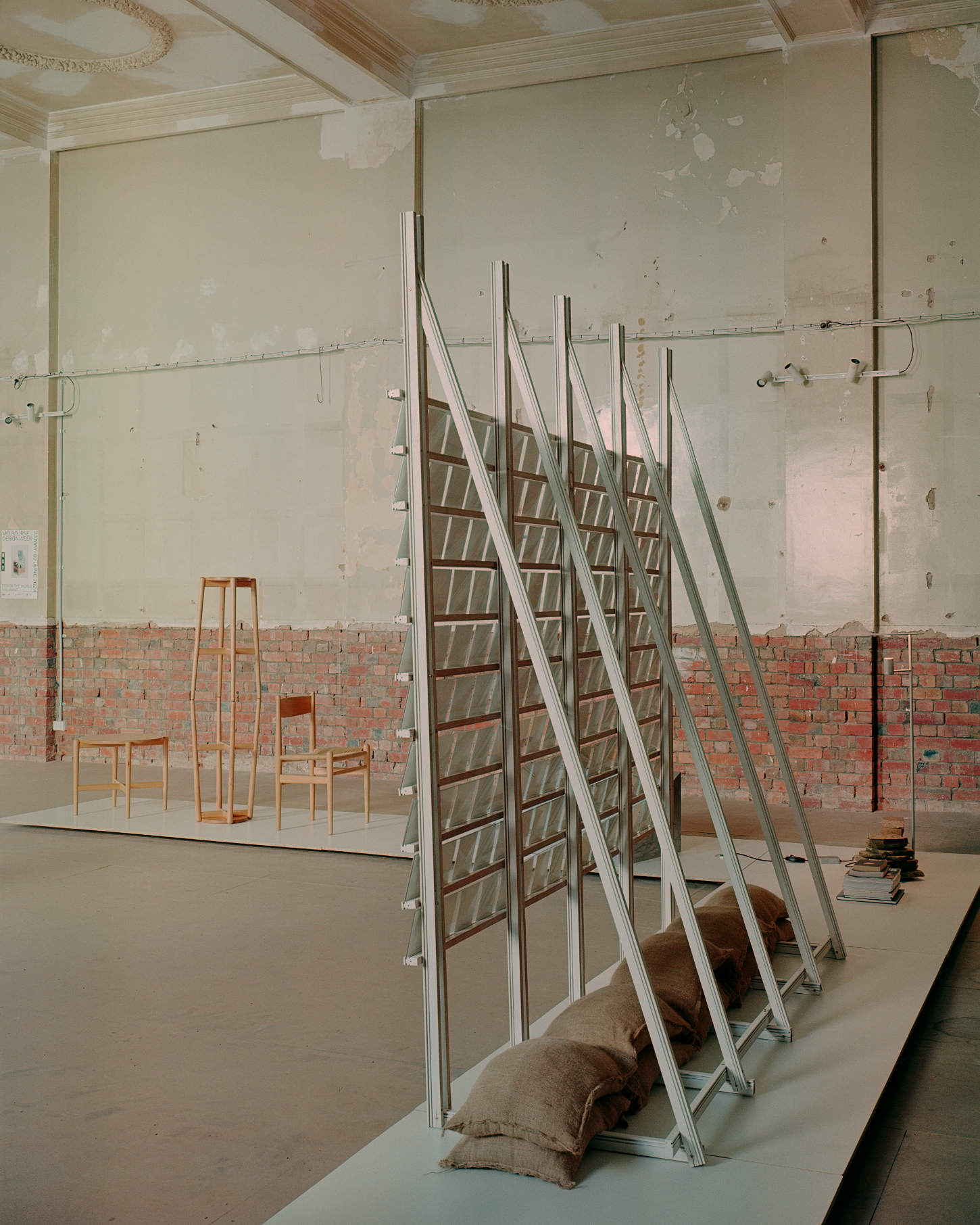 'Call Out' by DO WORKS — DO WORKS' installation for Melbourne Design Week 2024 presents a series of timber ladder structures in pine, leaning at progressive angles across a gallery...