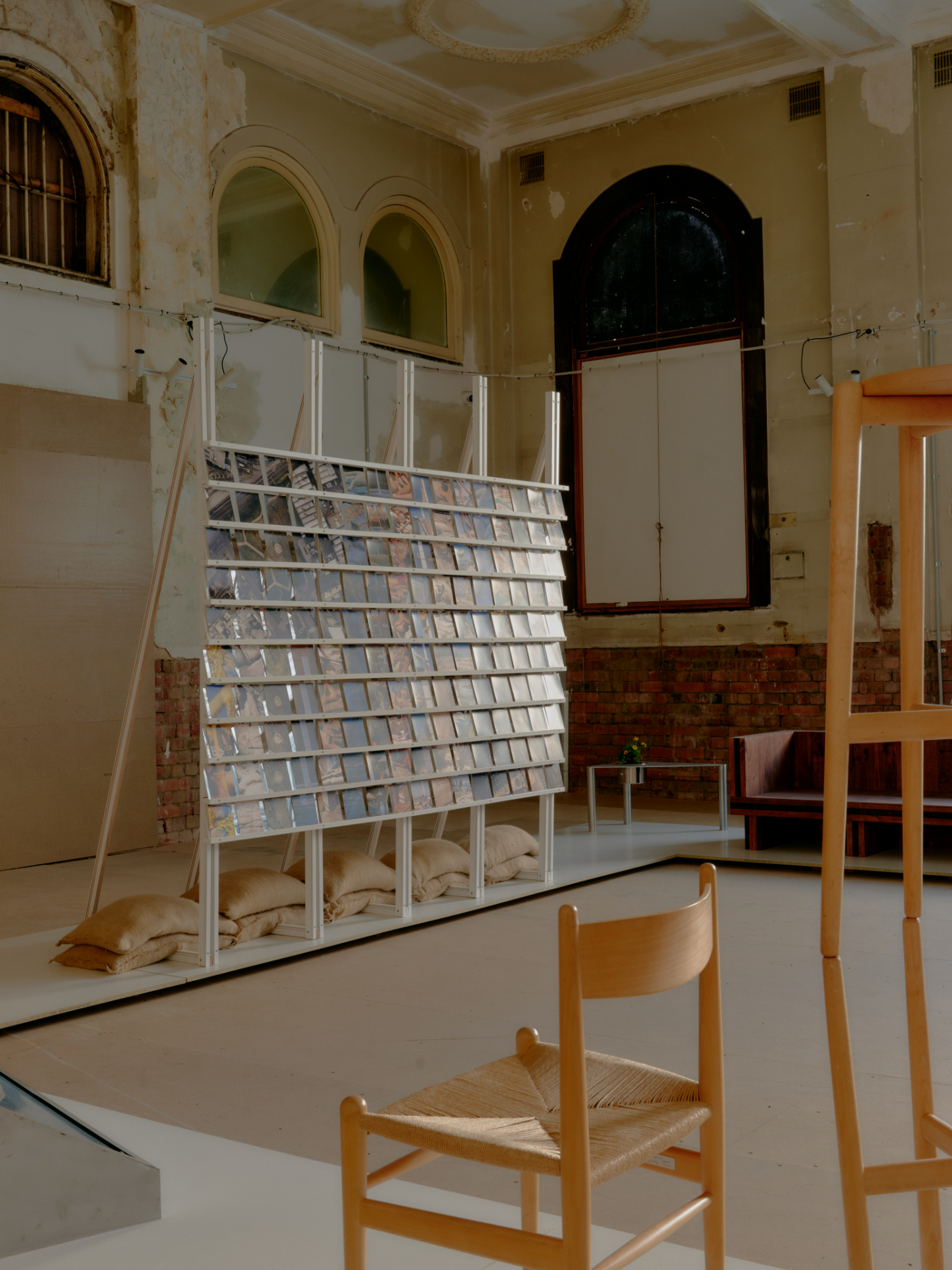 'Call Out' by DO WORKS — DO WORKS' 'Call Out' installation features a lean-to shelving structure constructed from steel tubing and metal mesh, displaying fabric samples or tile...