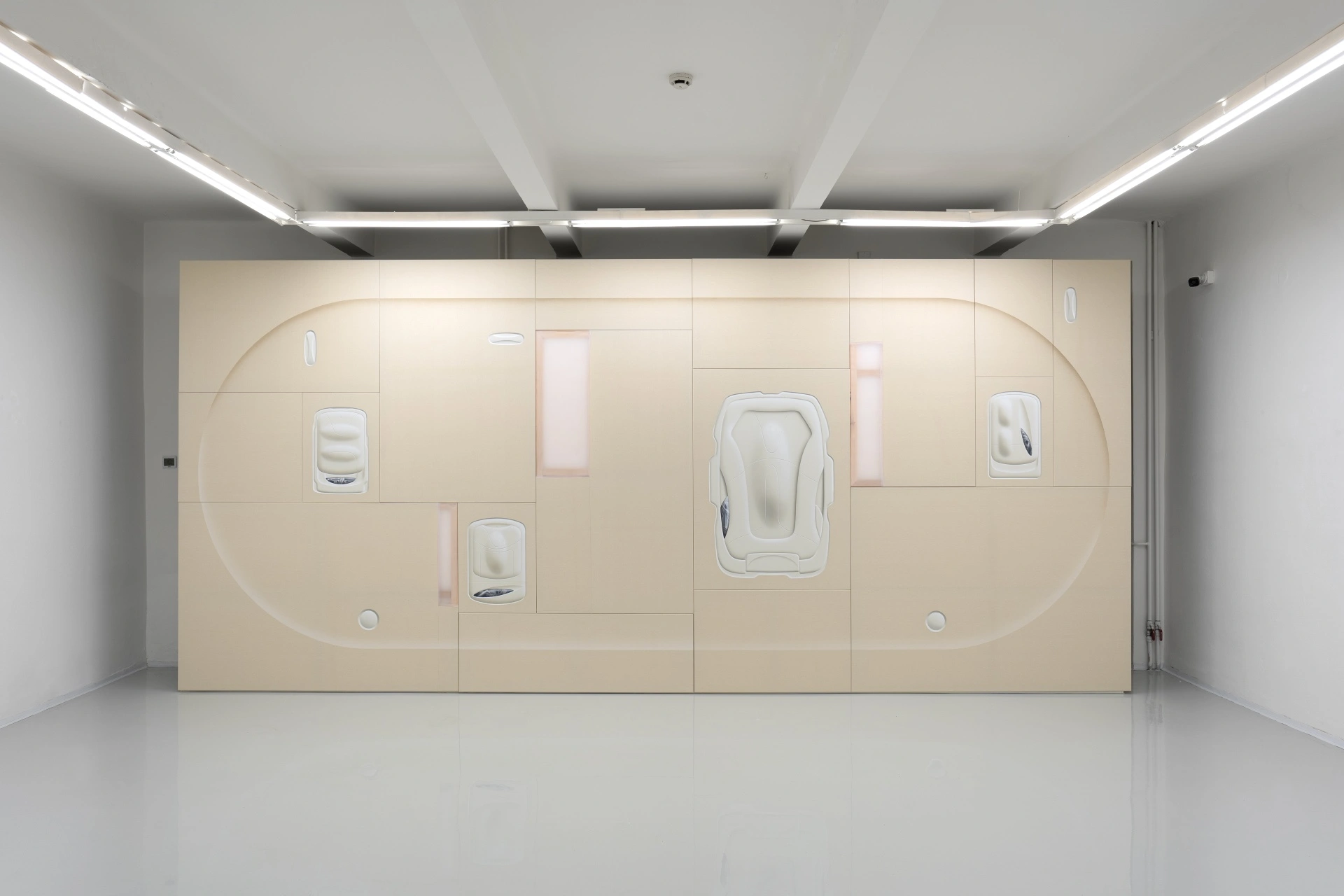 [face_not_recognized] by Milan Vagač — A monolithic beige plywood installation dominates the gallery interior, rendered in a single continuous surface interrupted by modular panel divisions.