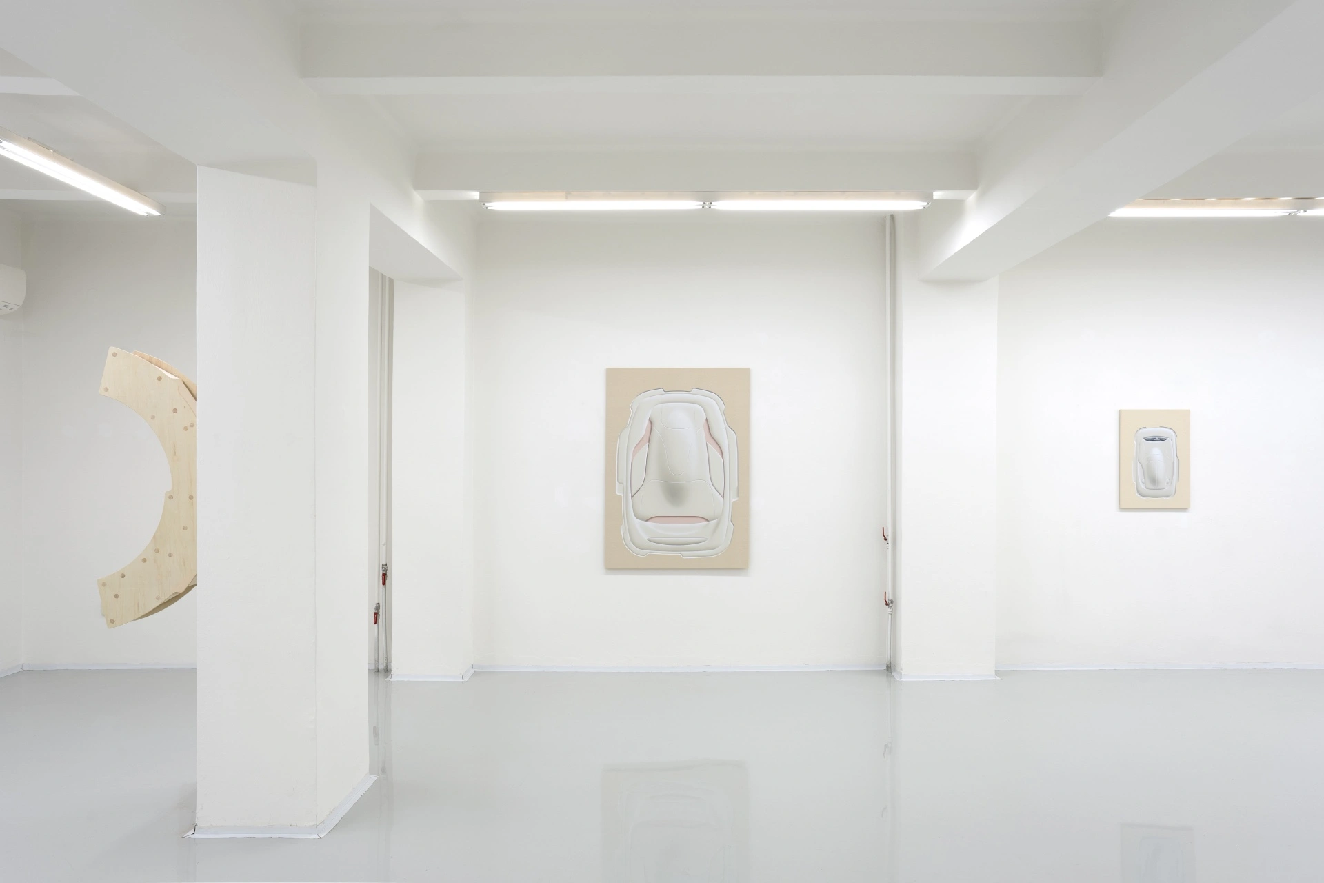 [face_not_recognized] by Milan Vagač — A minimalist gallery interior presents three works on pale plywood panels mounted at varying scales across white walls.