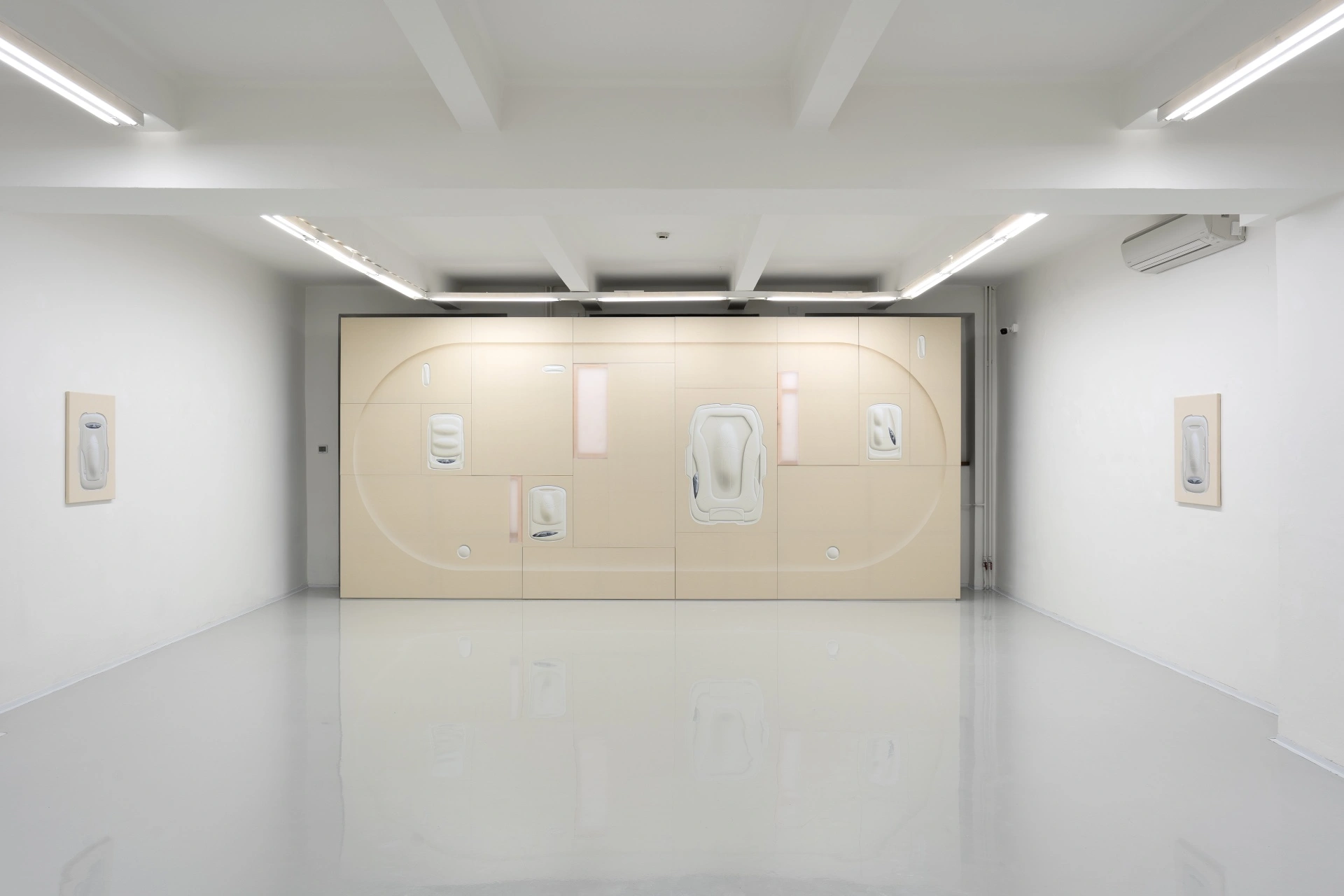 [face_not_recognized] by Milan Vagač — A gallery interior presents a monumental cream-colored installation dominating the rear wall.