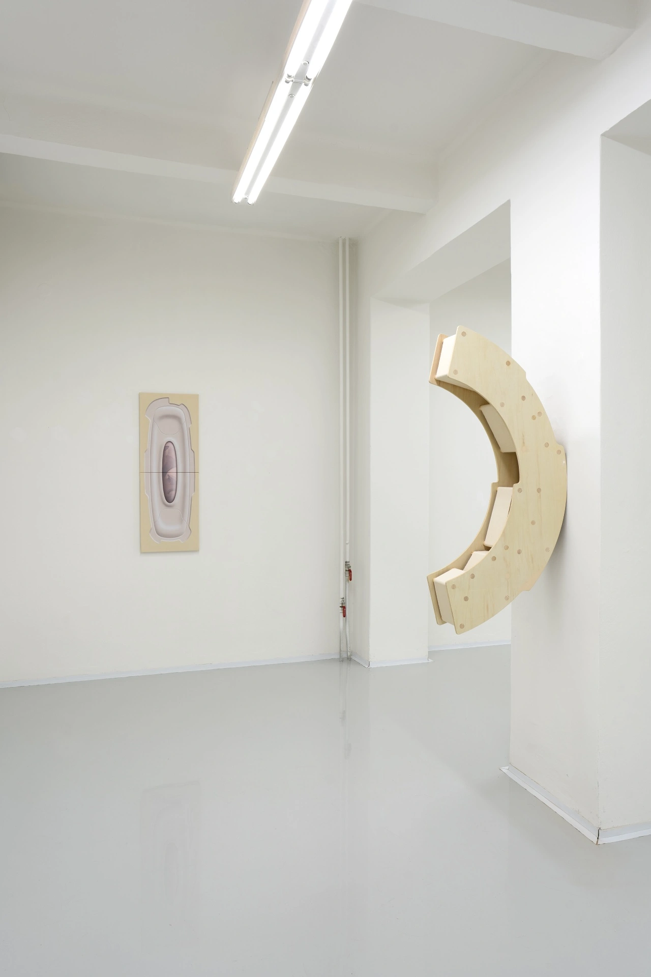[face_not_recognized] by Milan Vagač — A gallery interior presents two wall-mounted wooden sculptures in natural pine or light plywood.