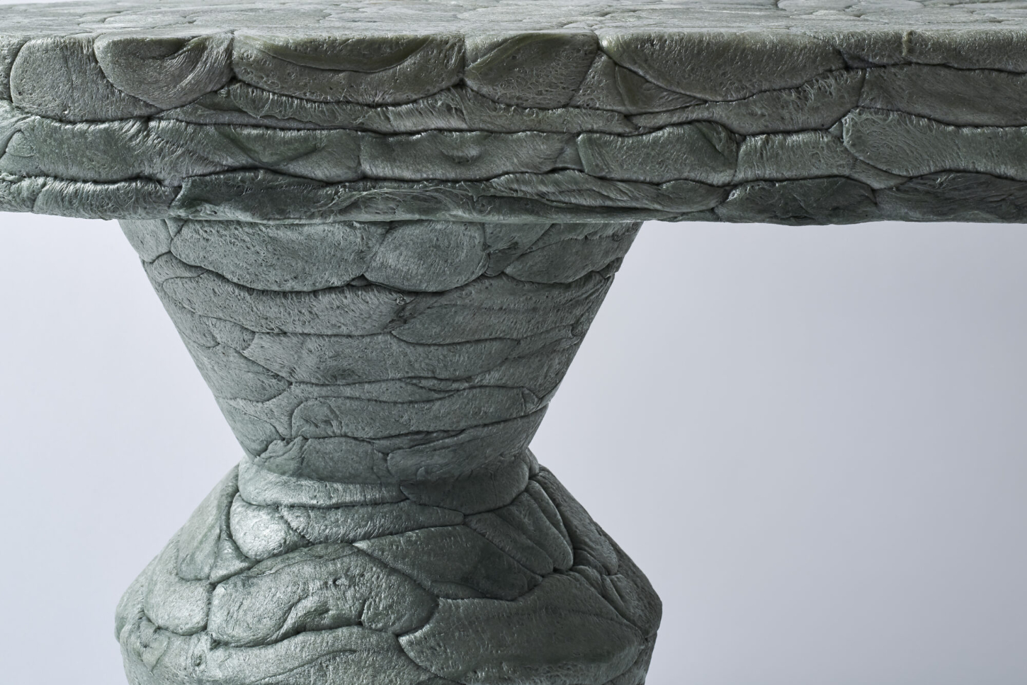 Refoam by We+ — A carved concrete capital or ornamental pedestal base photographed in close-up detail.