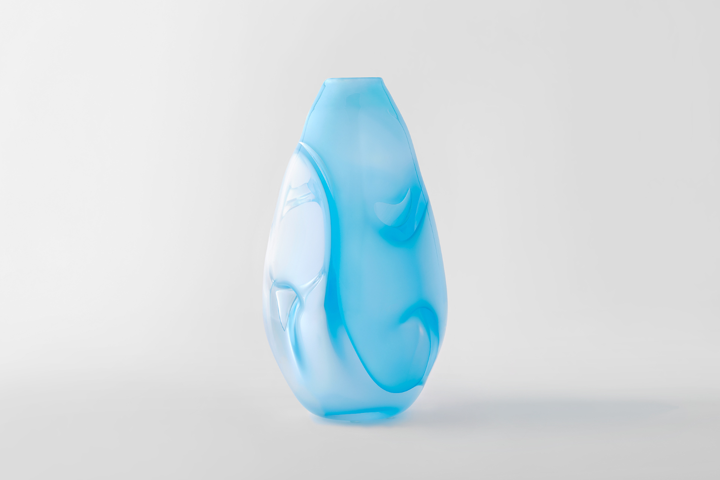 Selected works by Philipp Weber — A hand-blown glass vessel with teardrop proportions and swirled blue gradations from pale cyan to deeper azure.