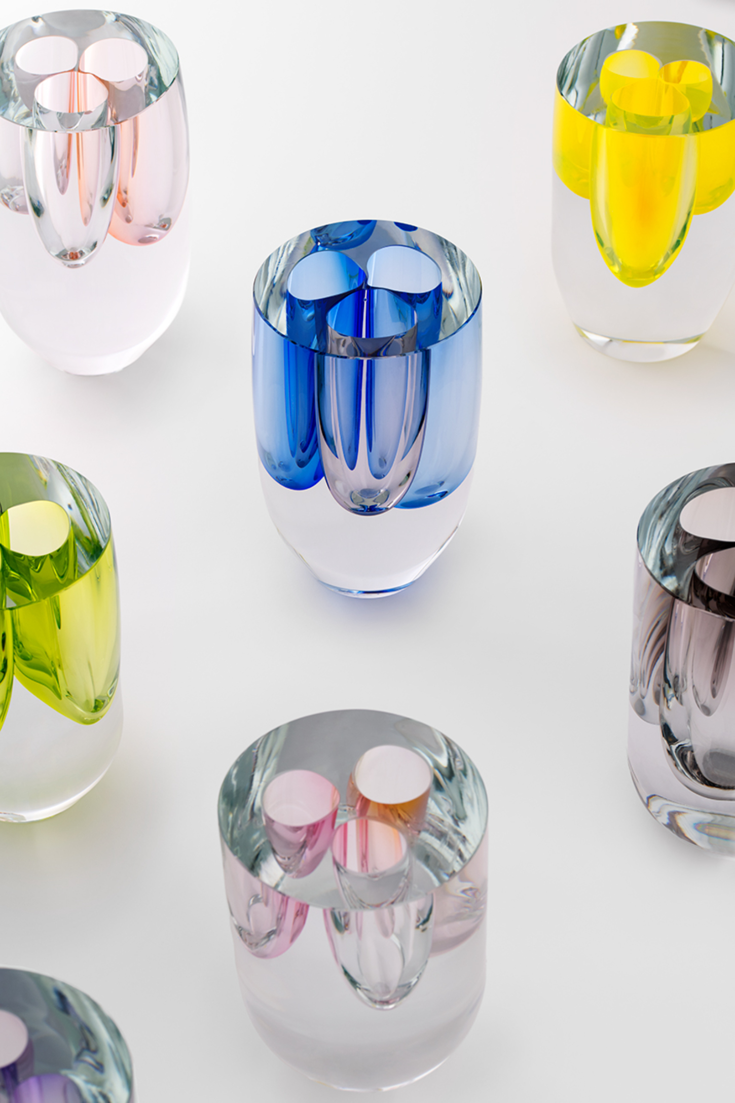 Selected works by Philipp Weber — A collection of hand-blown glass vessels arranged in a grid composition against a white background.