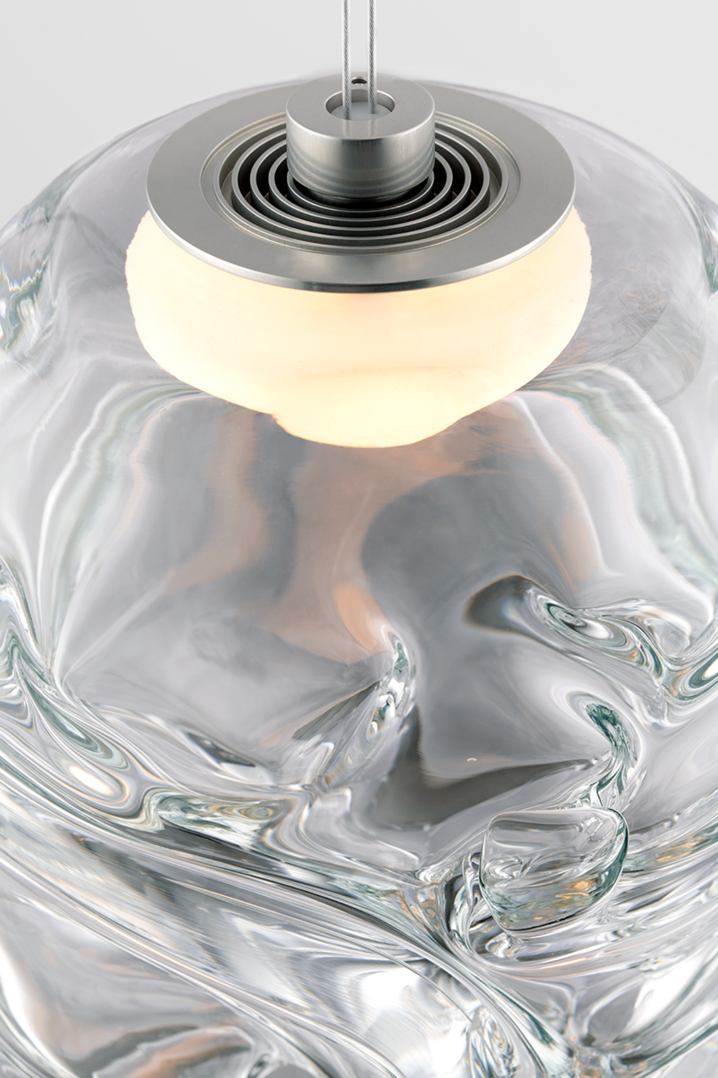 Selected works by Philipp Weber — A hand-blown glass pendant with swirled, fluid surface patterns in clear and frosted tones creates internal depth through organic distortions.